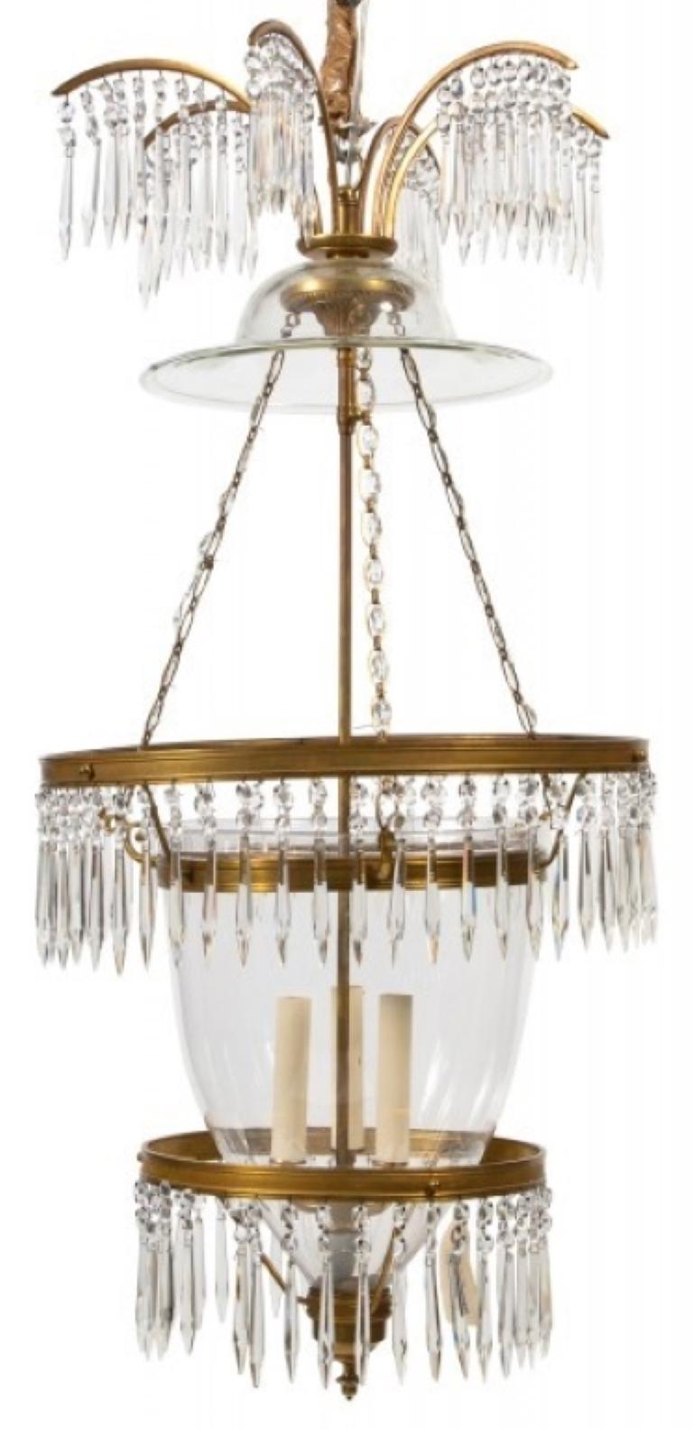 A marvelous and impressive pair of Russian crystal & ormolu mounted three-light lantern chandeliers. A pair of Russian neoclassical style lantern chandeliers with hand-diamond cut crystal prisms in an impressive addition to any room. These