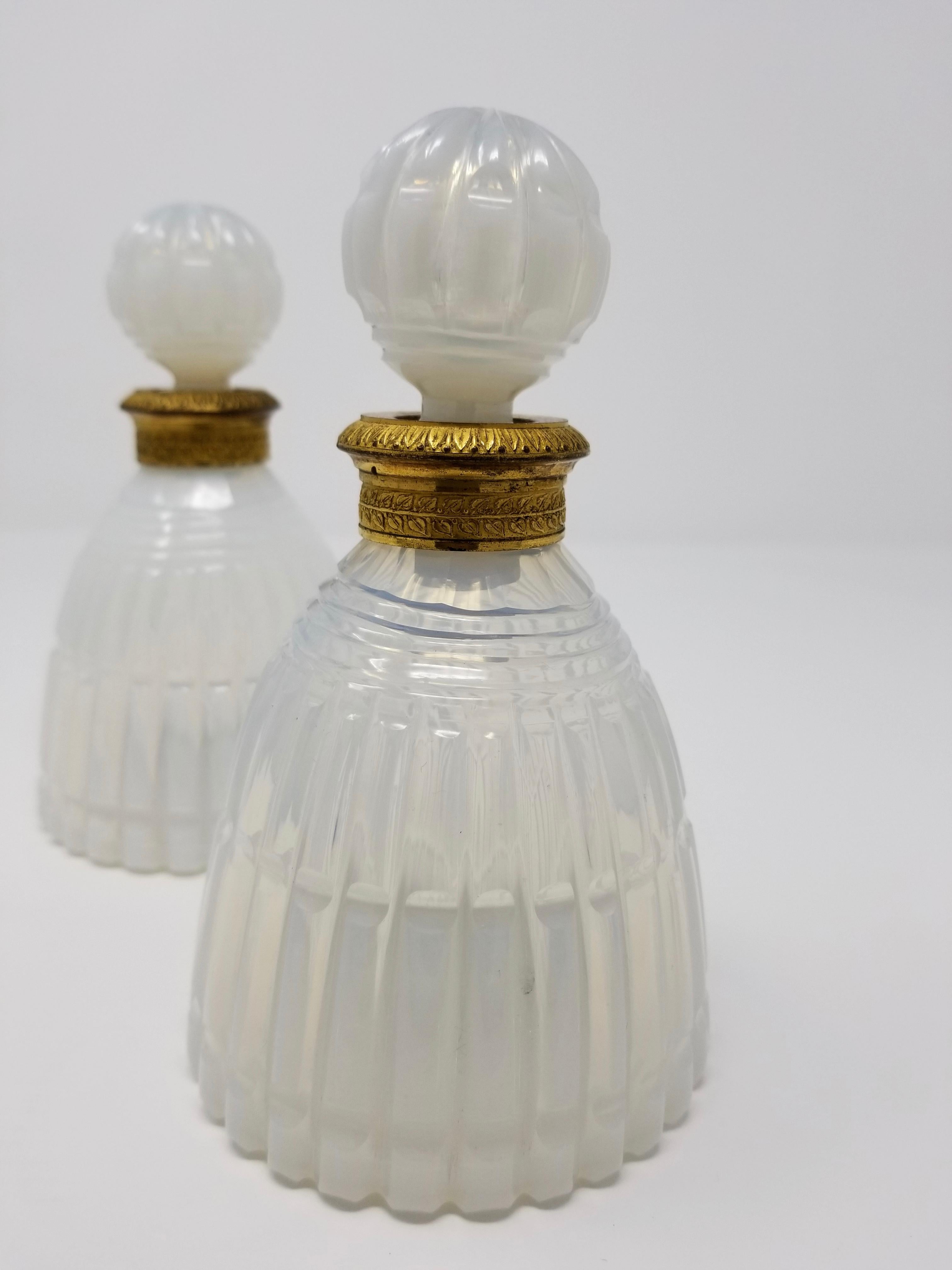 A fine pair of 19th century Louis XVI style Russian hand diamond-cut white opalescent crystal and ormolu-mounted perfume bottles. This pair of hand diamond-cut crystal perfume bottles are truly beautiful. The crystal has a gorgeous milky-white