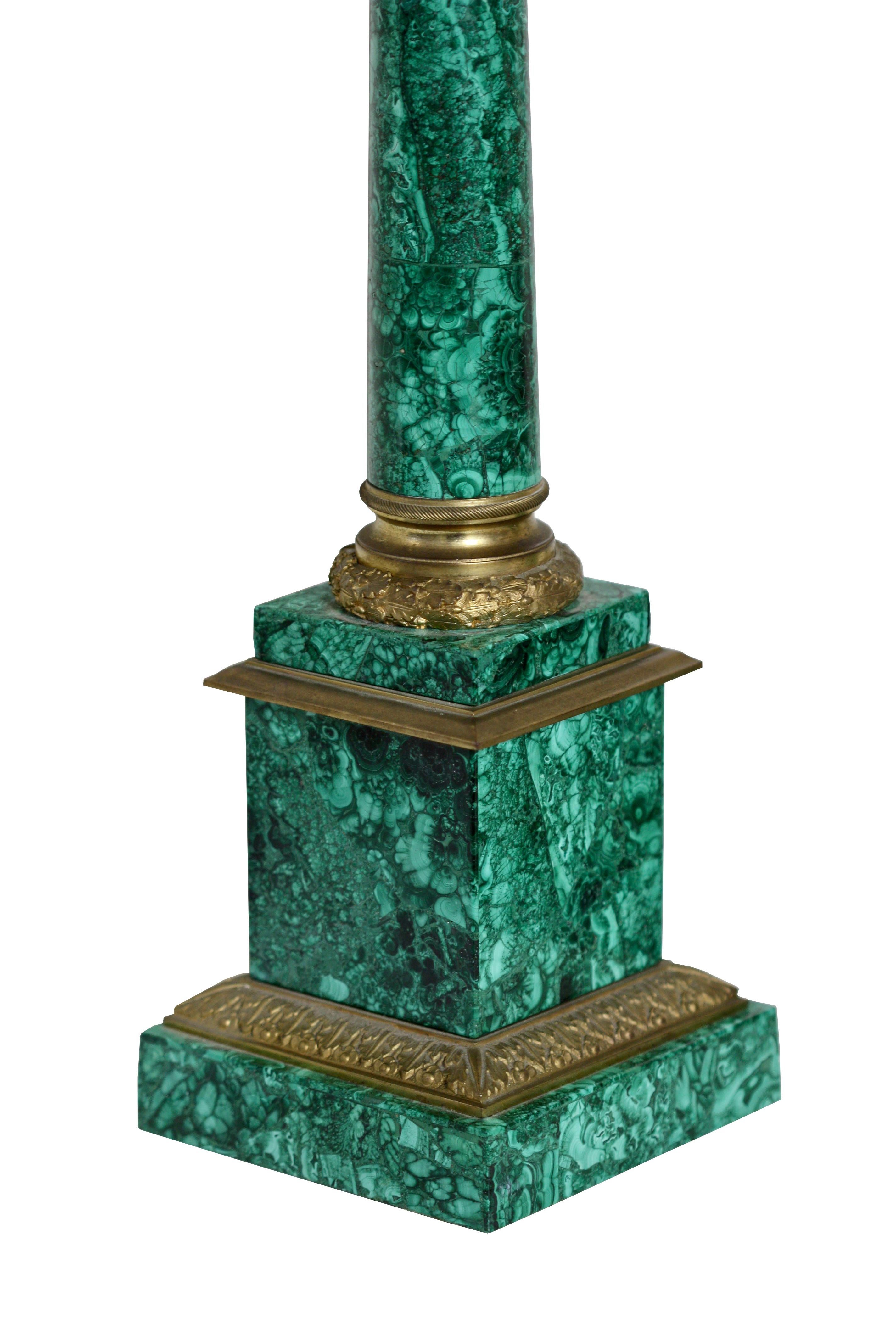 A pair of Russian style gilt-bronze mounted Malachite three-light candelabra
Fourth quarter of the 19th century
the round columns on a square plinth on bronze feet and issuing three S-shaped branches
Height 2ft. 3.12 in. (68.89 cm.); Width 5.12