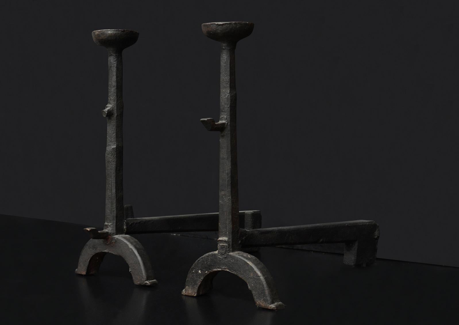 A pair of rustic cast iron firedogs with arched feet, tapering shafts and mulling top finials. English. Heavy and imposing.

Measures: Height: 615 mm 24 1/4 in
Width: 280 mm 11 in
Depth: 580 mm 22 7/8 in.