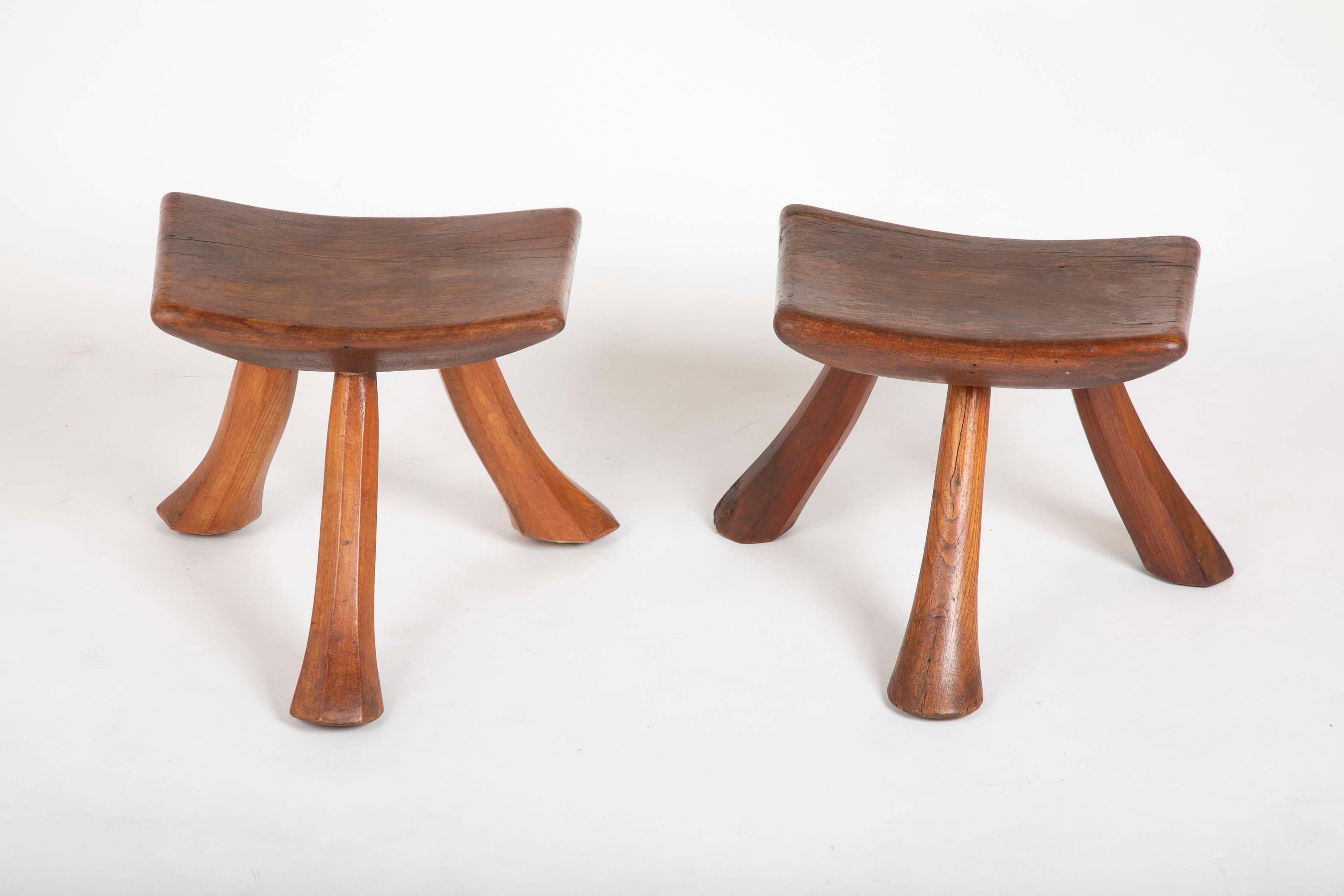 A pair of three-legged Maple stools with wonderful patina.