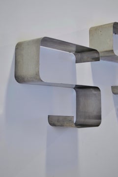 A pair of S-shaped stainless steel shelves "Zig Zag" Joelle Ferlande 1970