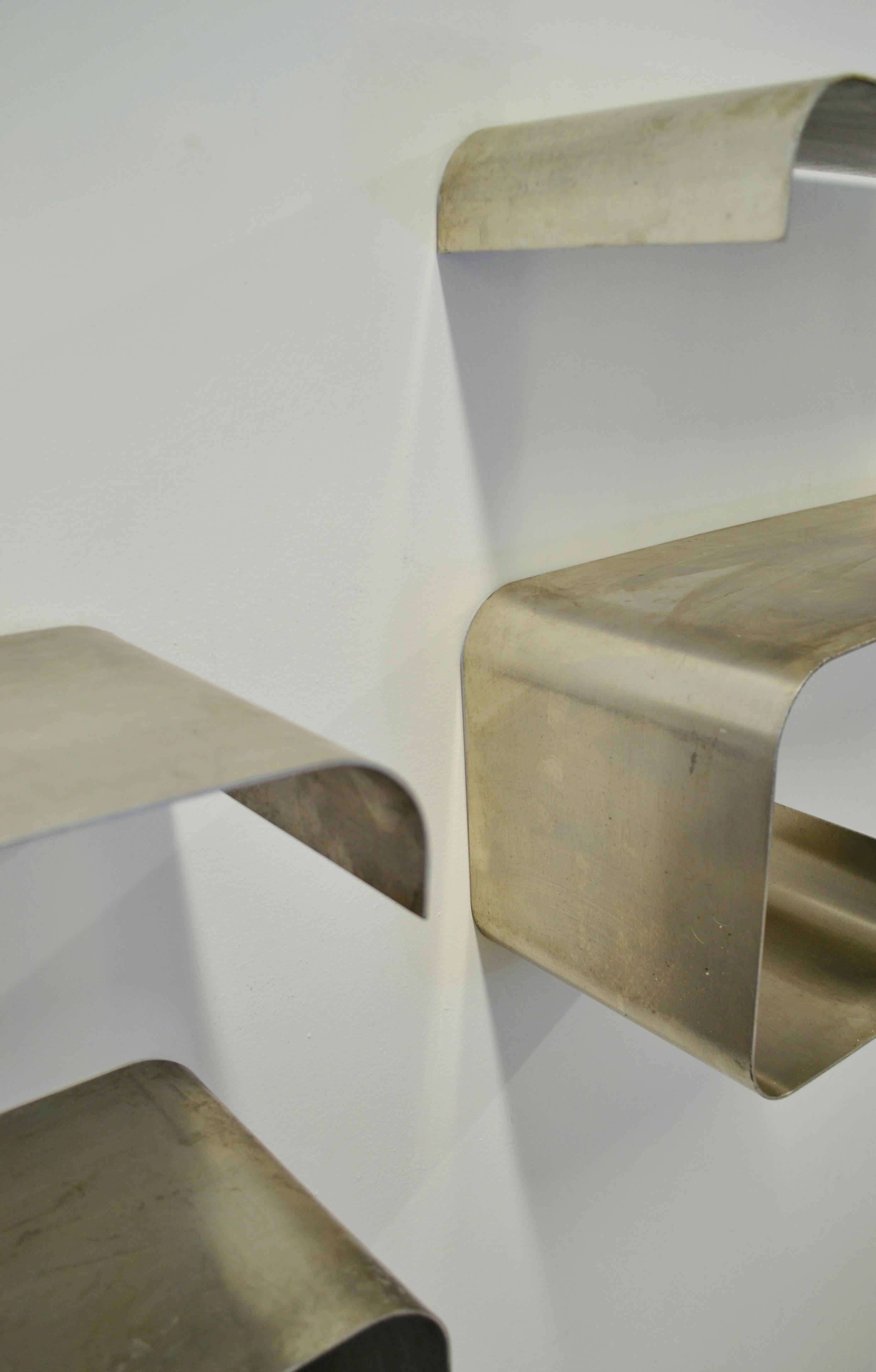 A pair of S-shaped stainless steel shelves 