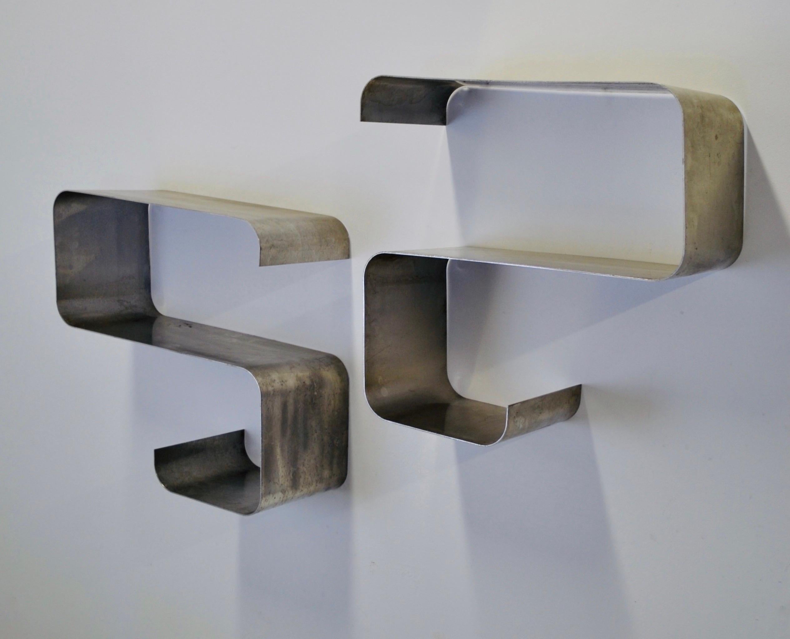 A pair of S-shaped stainless steel shelves 