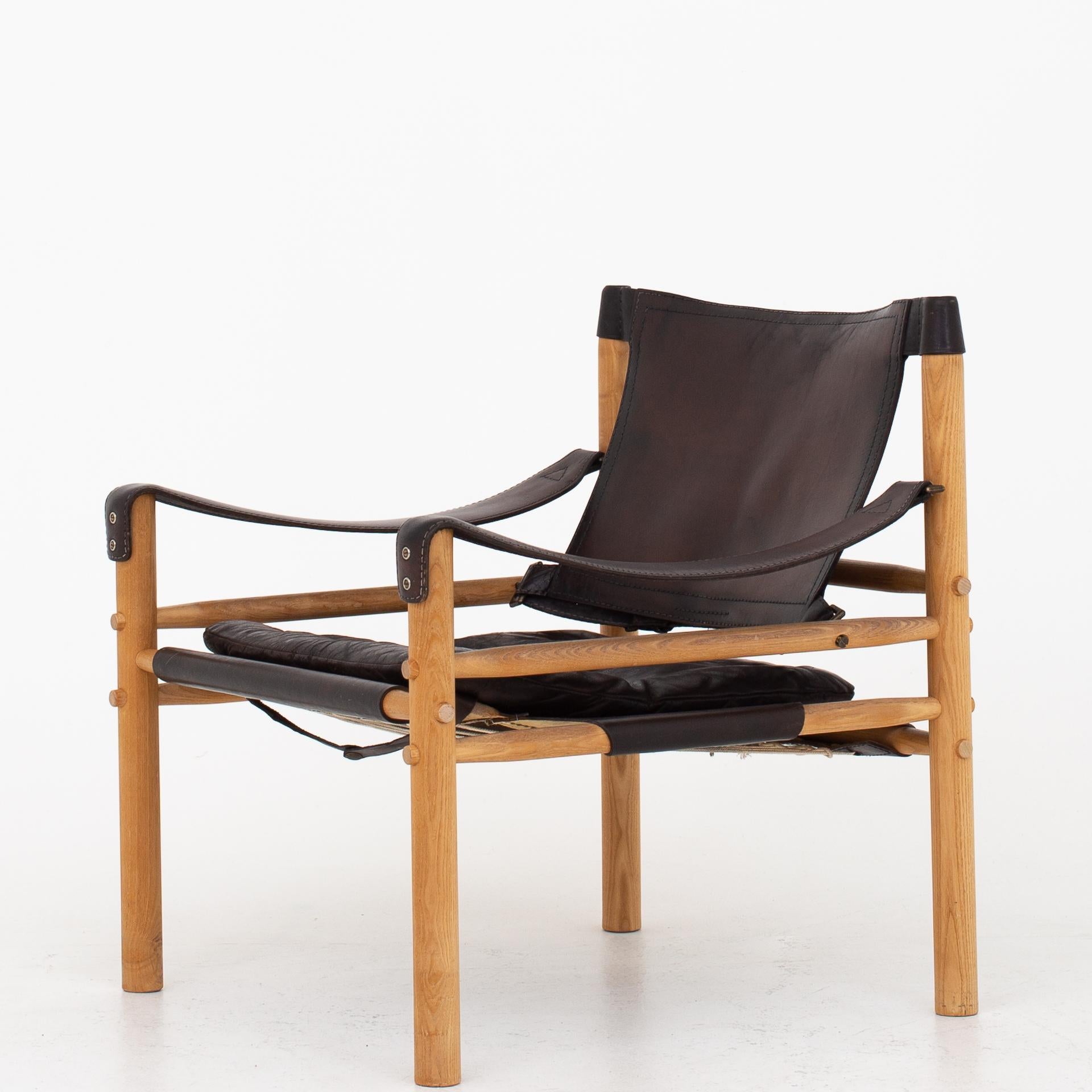 Two Scirocco safari chairs in ash and patinated black leather. Maker Norell Möbler AB.