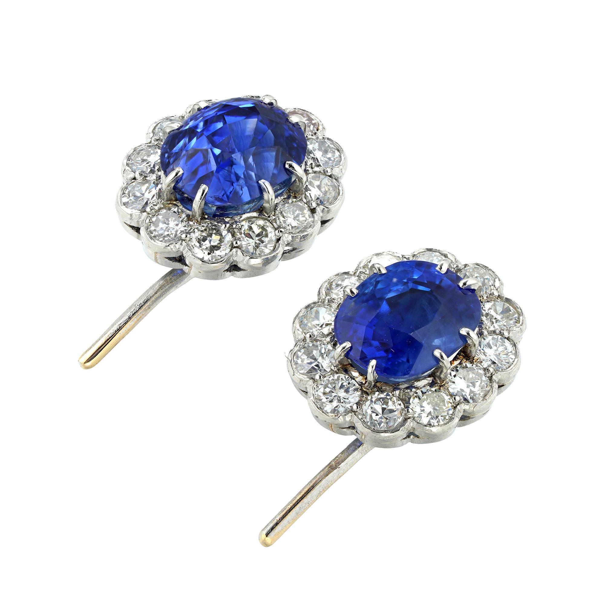 A pair of vintage sapphire and diamond cluster earrings, each earring with a cushion-cut sapphire, the one weighing 3.25 carats and the other 2.20 carats, accompanied by GCS Report stating to be of Sri Lankan origin with no indication of heating,