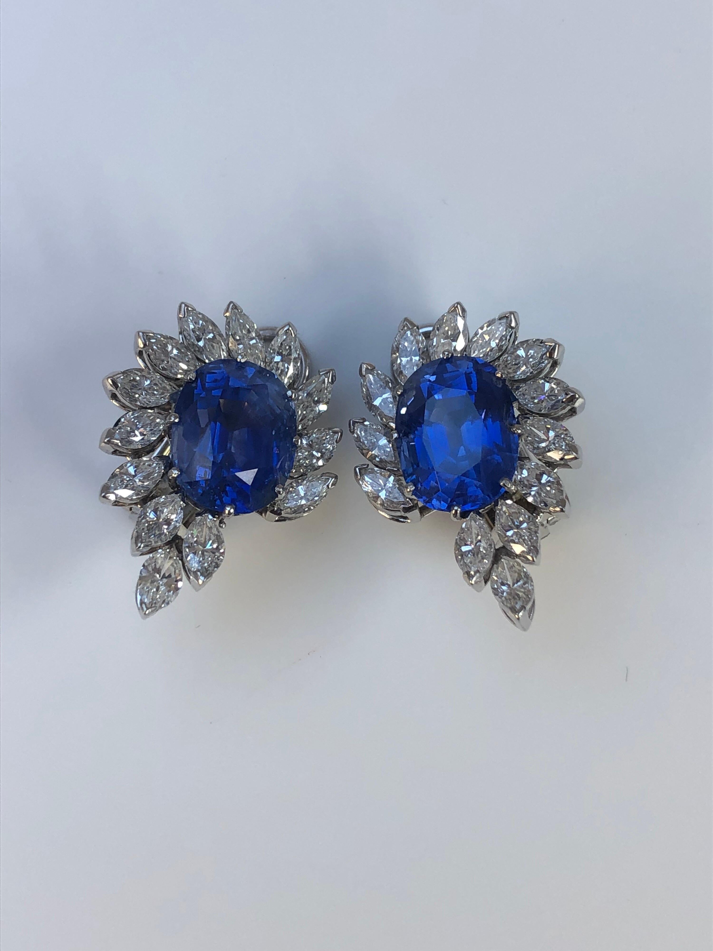 A Very Stylish Pair of Sapphire and Diamond Earrings with two natural untreated sapphires weighing a total of 14.92 carats and certified by SSEF. The well matched antique cushions cut sapphires are set within a surround of marquise shaped diamonds