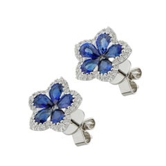 A pair of sapphire and diamond flower cluster earrings