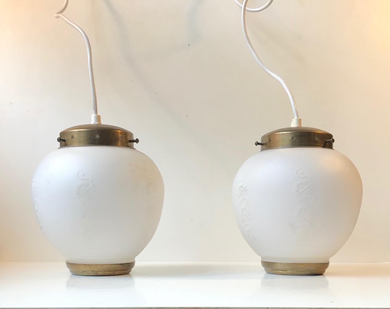A pair of Scandinavian ceiling lights manufactured and designed during the 1950s. Probably by Lyfa in Denmark. However they remain unattributed. They are made from patinated brass and have a center shade in partially decorated white milk or opaline