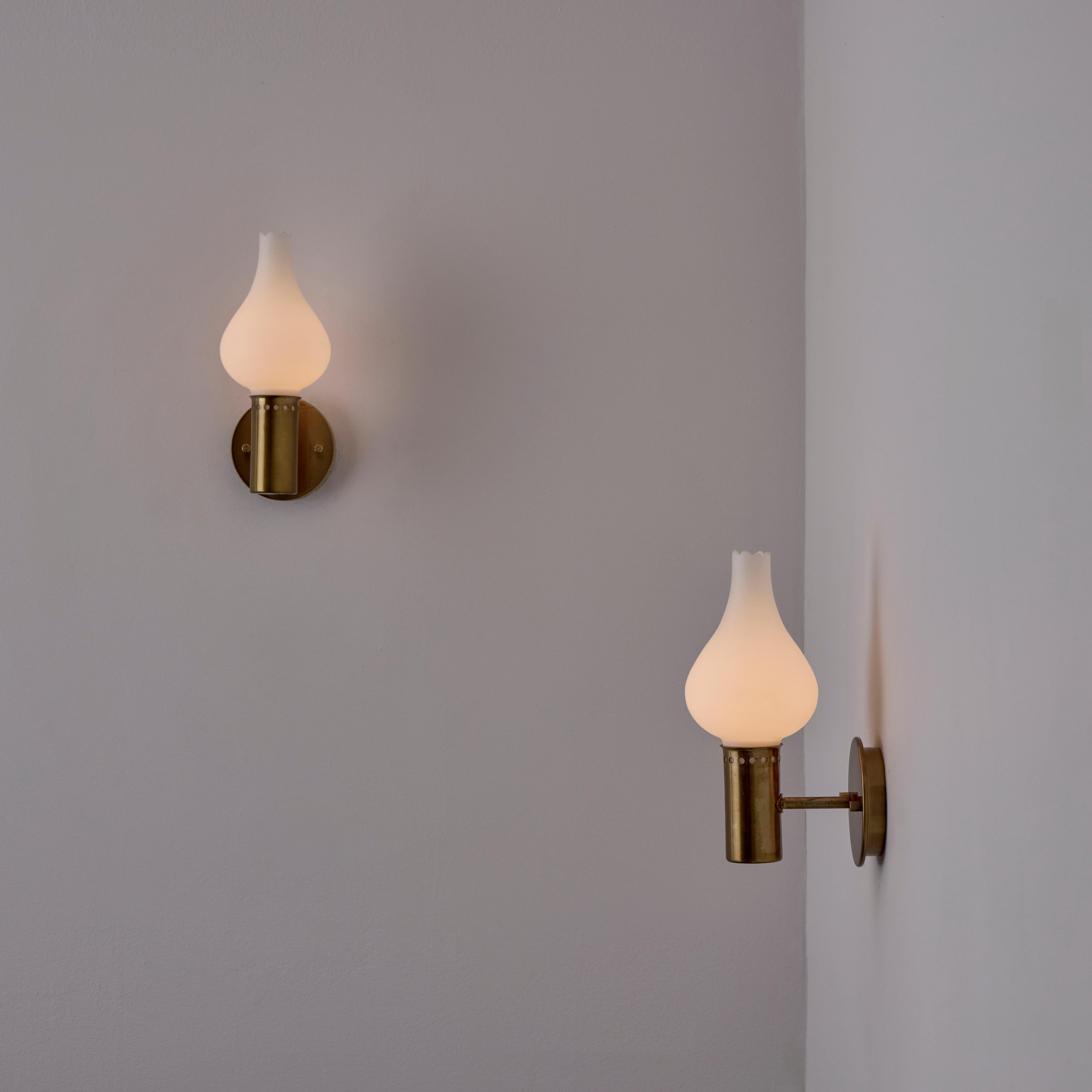 A Pair of Sconces by Hans Agne Jakobsson for Markaryd (Sweden, 1960s)

Opaline glass diffusers, featuring a pointed cut rim detail. Polished brass details on the armature. Rewired for the US. Holds a single E14 socket type, adapted for the US. Sold
