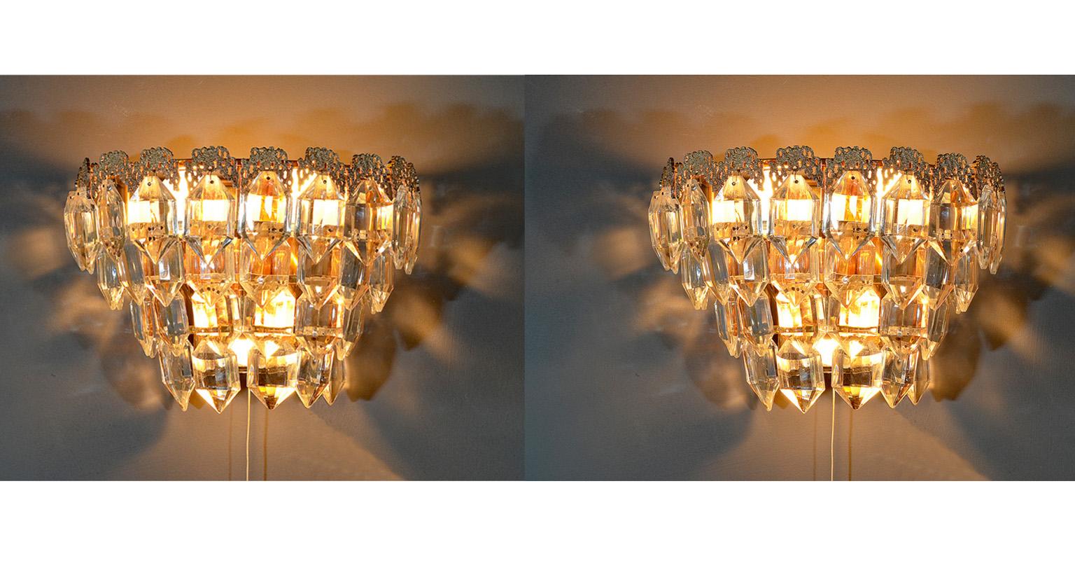 A pair of sconces / wall lights from Bakalowits, Austria, 1960s. Gilt brass and faceted glass.