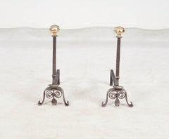 A Pair of Scrolled Iron and Bronze Andirons
