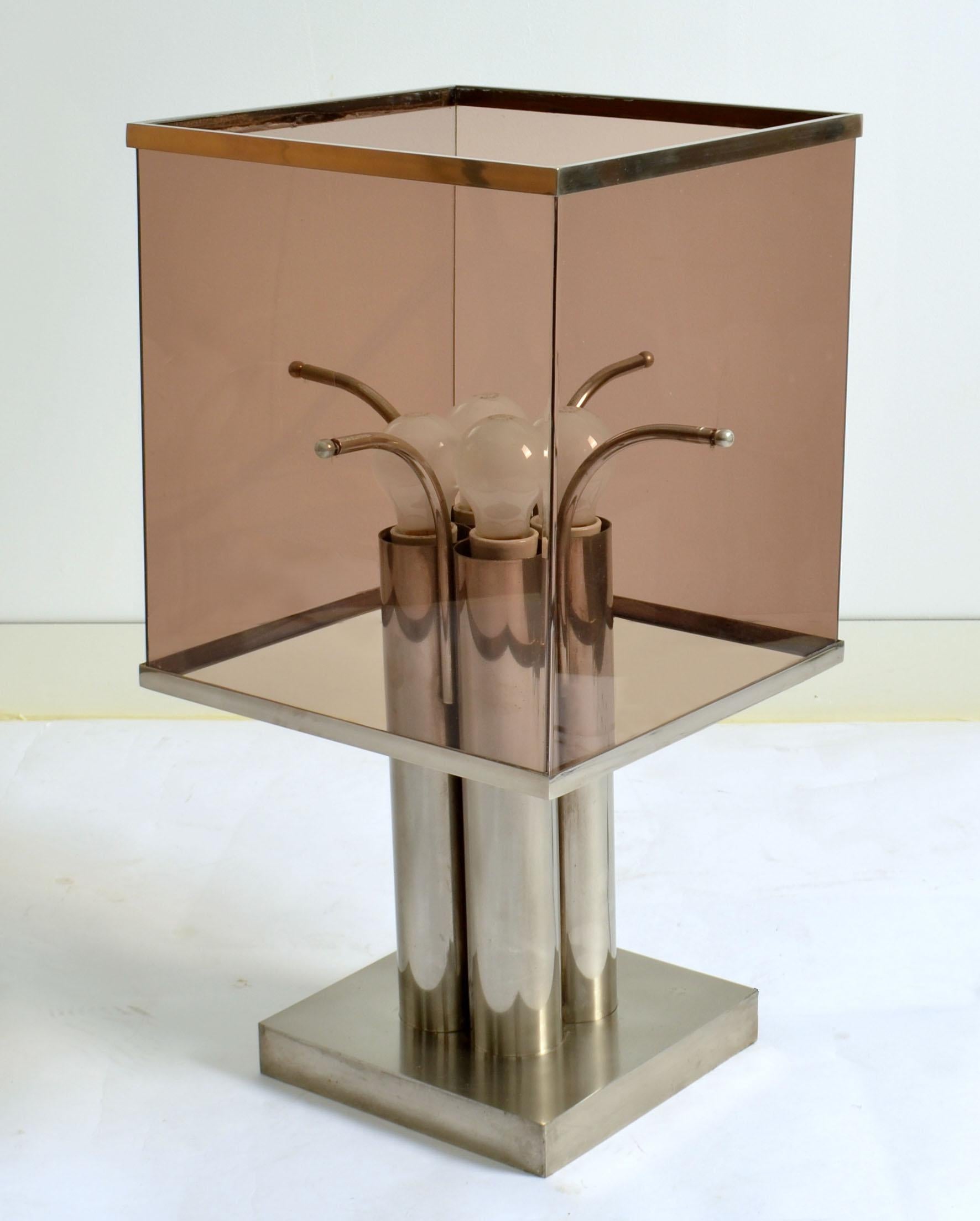 Pair of large sculptural Minimalist in nickel and dusty mauve Lucite table lamps by Romeo Rega, Italy 1960's. Structured base has four round pillars on a square base each holding a bulb. The square tinted Lucite shades are edged with chrome rims at