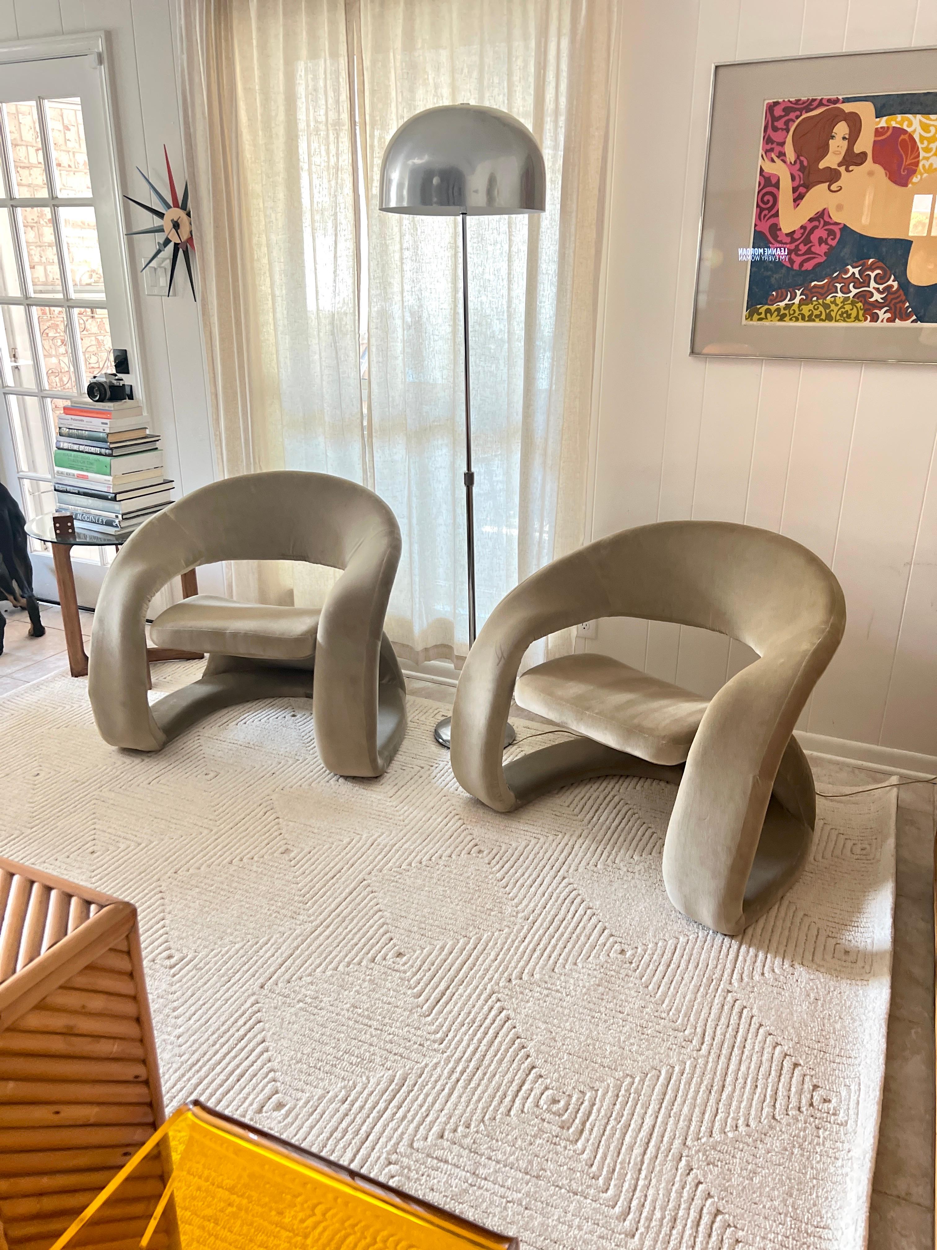 A pair of sculptural tongue chairs in the style of Jaymar, circa 1980s-1990s. Recently recovered in a sage green velvet fabric (100% cotton), these chairs are just as stylish as they are comfortable. Overall in very good condition. There is no
