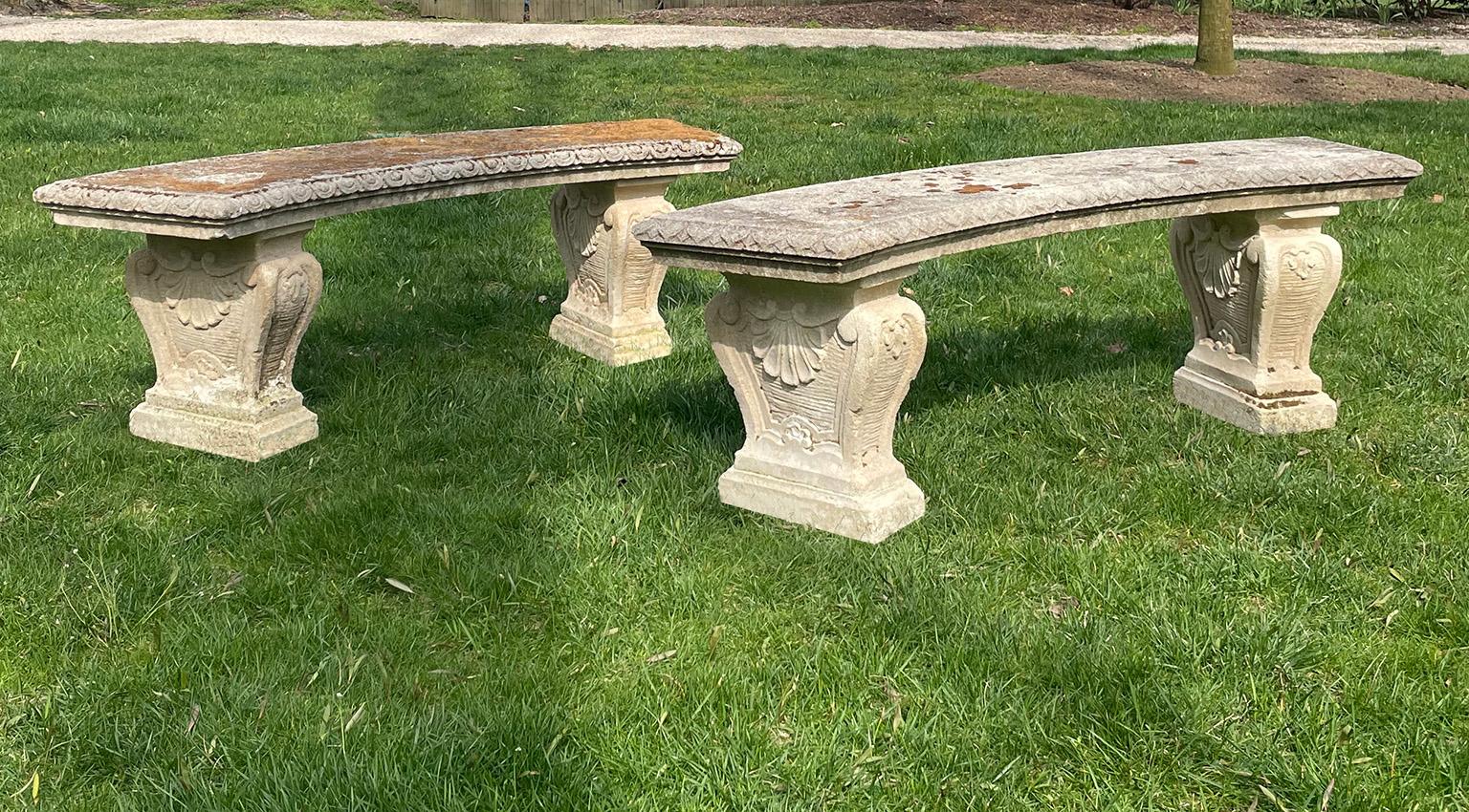 A pair of carved Vicenza stone benches with curved tops, the tops with egg and dart motif at the edges, the supports with shell and stylized floral motifs, Italian, circa 1940. 19.5 ins. high, 60.5 ins. long; seat depth 15.25 ins.
  