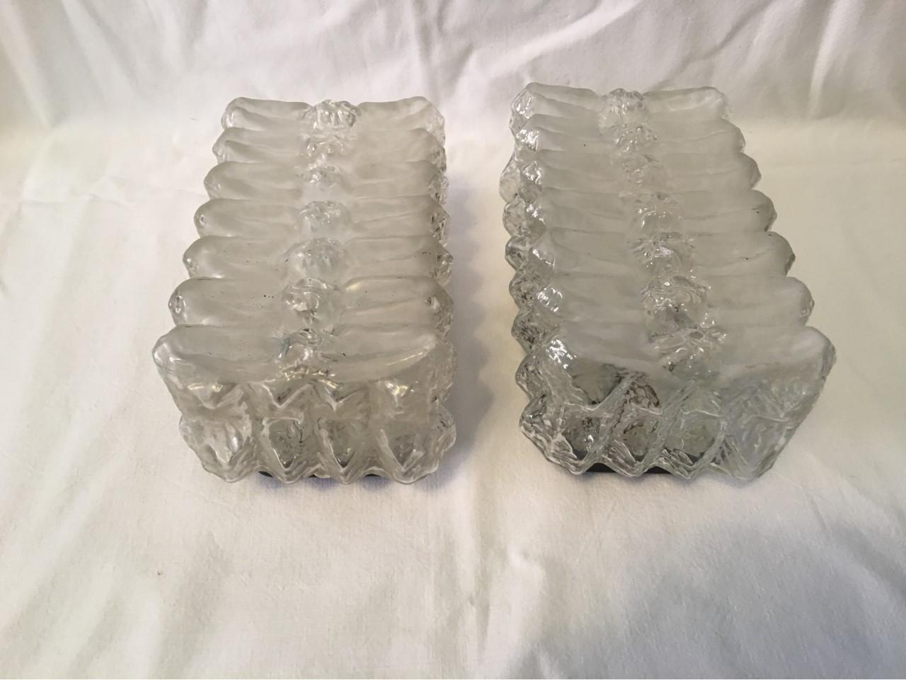 A pair of 1960s wall lamps made with a unique serrated glass pattern (