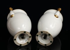 A Pair of Sevres Porcelain White Ground & 24K Gold vases w Lion Head Handles