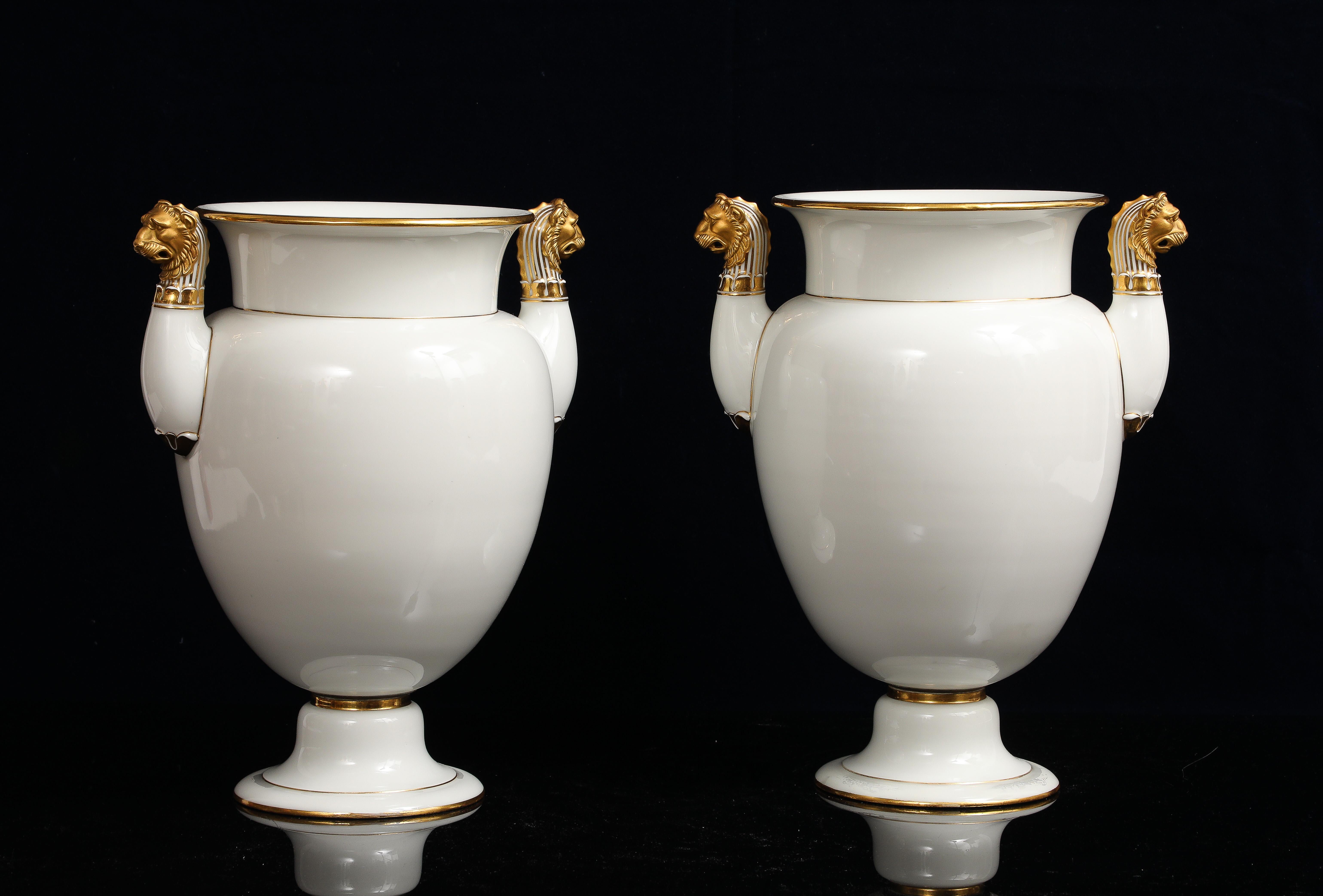 Neoclassico A Pair of Sevres Porcelain White Ground & 24K Gold vases w Lion Head Handles in vendita