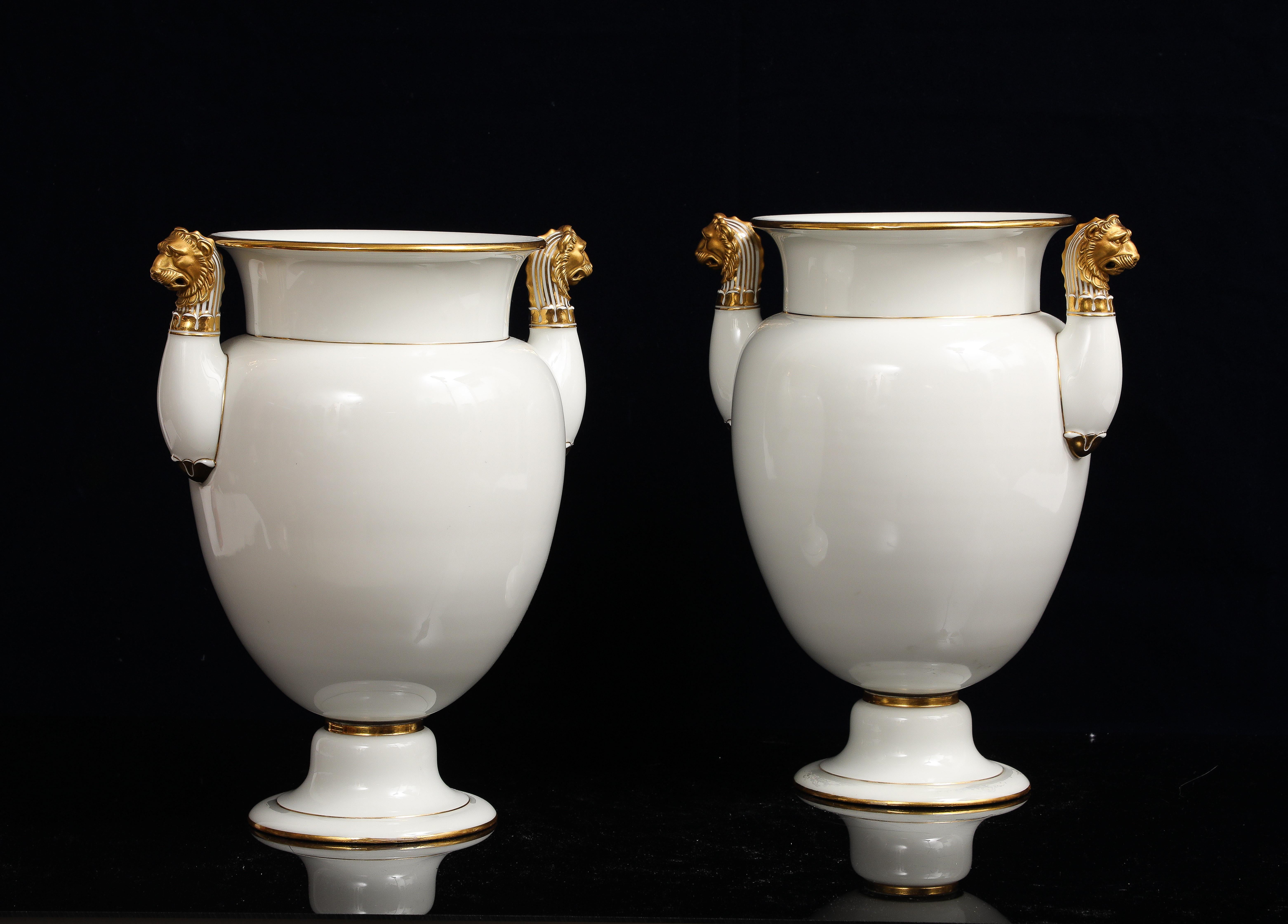 Dorato A Pair of Sevres Porcelain White Ground & 24K Gold vases w Lion Head Handles in vendita