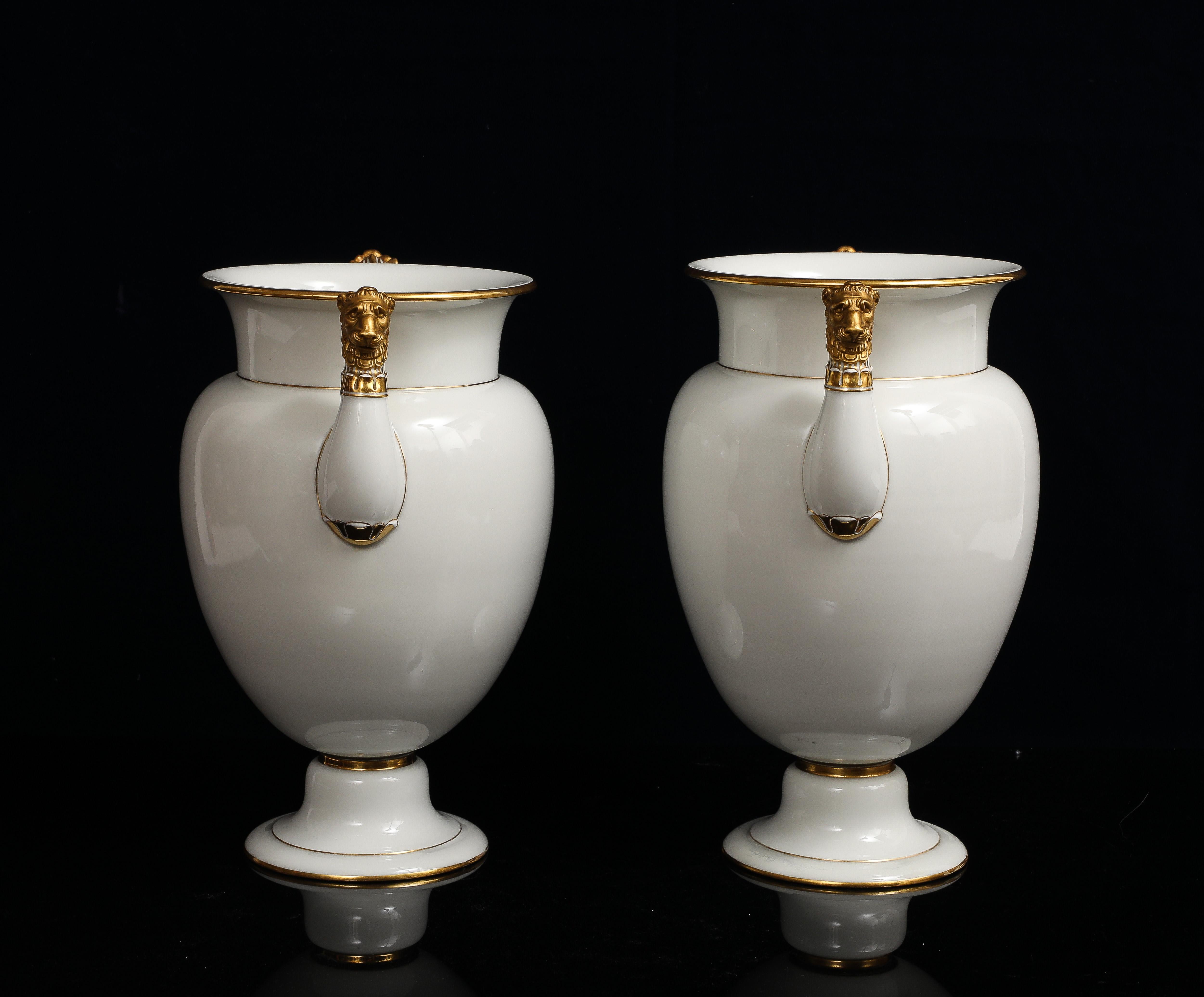 A Pair of Sevres Porcelain White Ground & 24K Gold vases w Lion Head Handles In condizioni buone in vendita a New York, NY