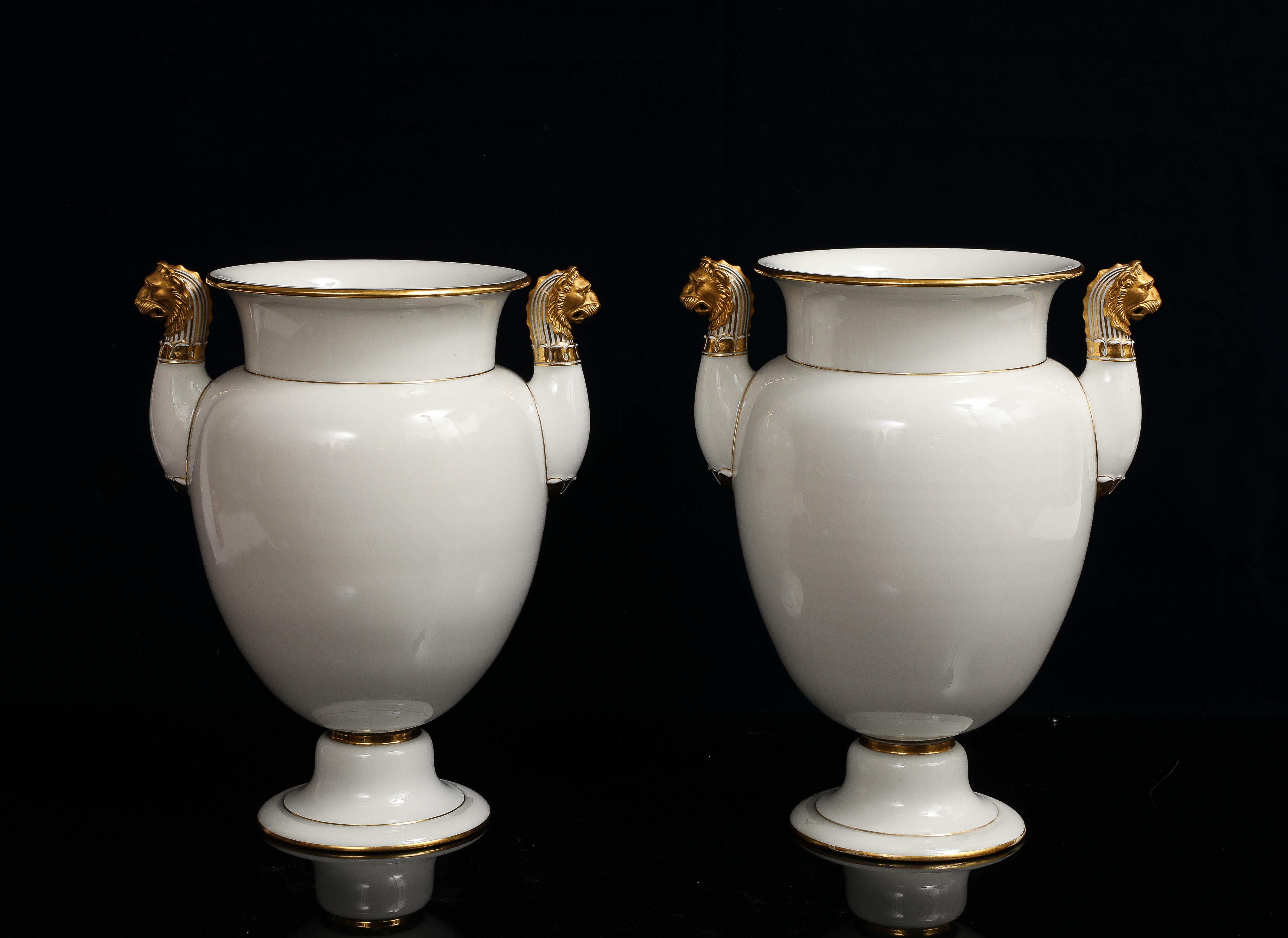Metà XIX secolo A Pair of Sevres Porcelain White Ground & 24K Gold vases w Lion Head Handles in vendita