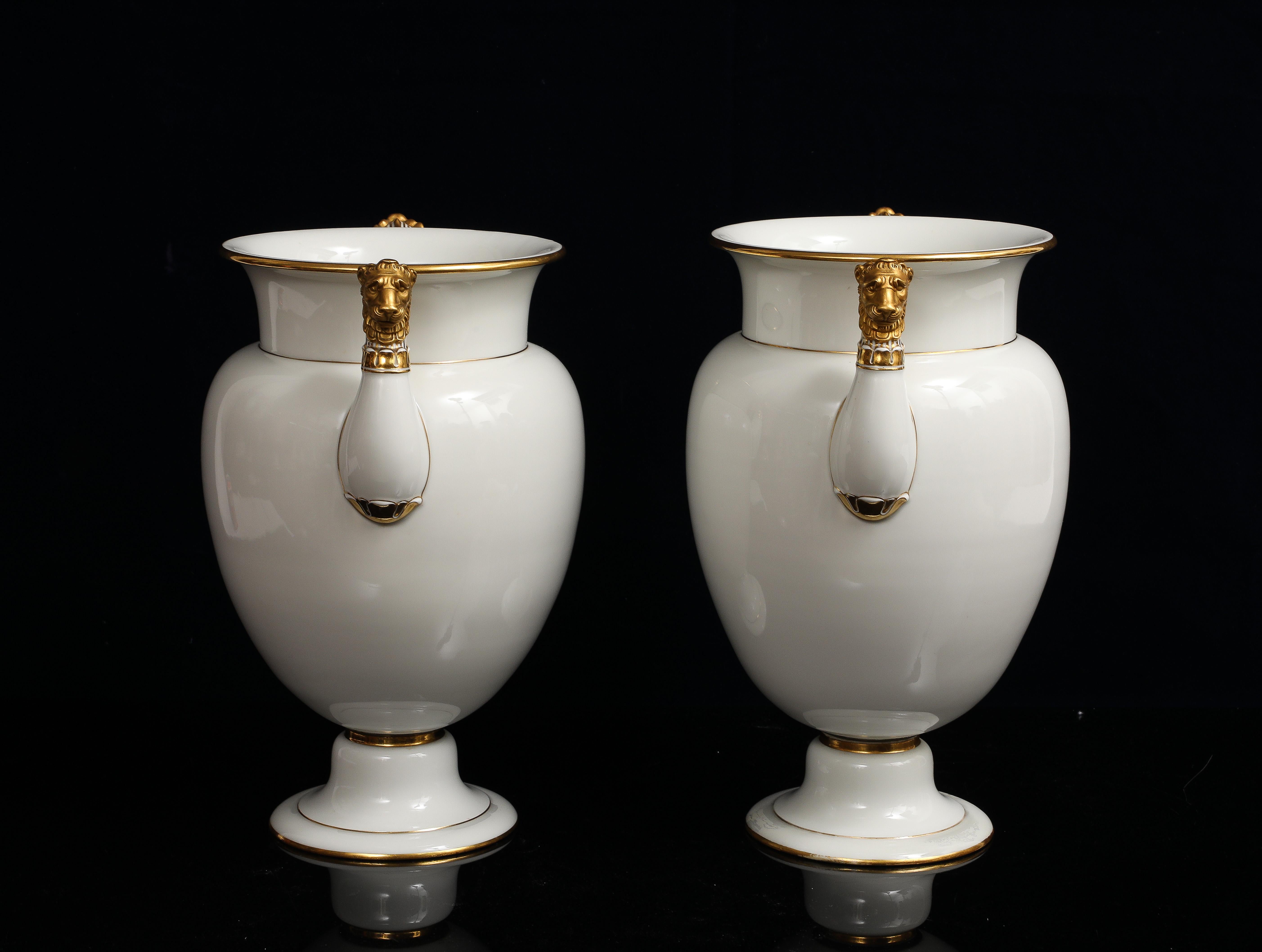 Oro A Pair of Sevres Porcelain White Ground & 24K Gold vases w Lion Head Handles in vendita