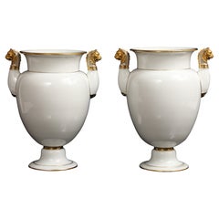 A Pair of Sevres Porcelain White Ground & 24K Gold vases w Lion Head Handles
