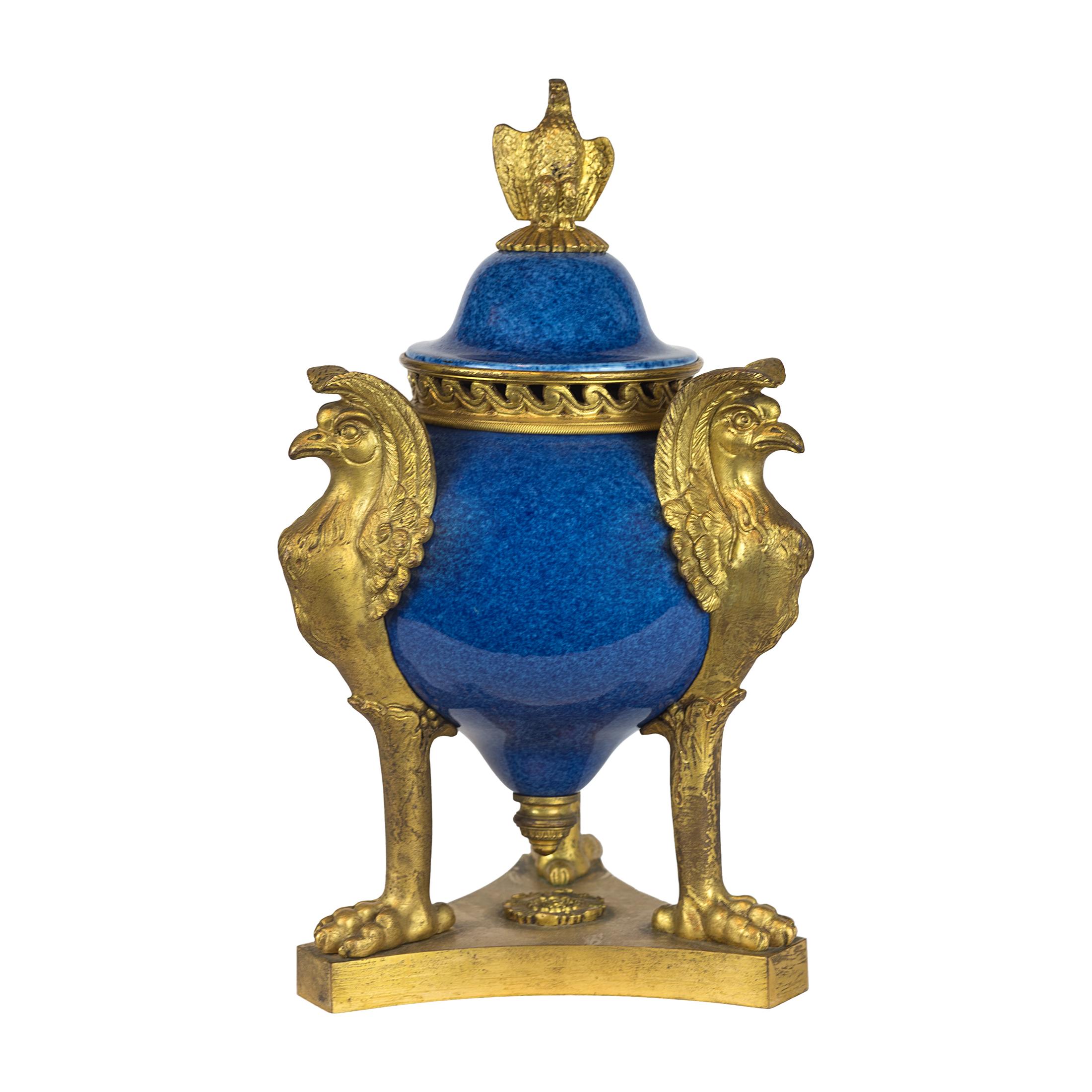 Pair of Blue-ground porcelain potpourri / incense vases with eagle finials and griffin supports. Removable lid and band of bronze at the neck of the vase with cut outs allows one to place potpourri or other perfumed items into the vase to enhance