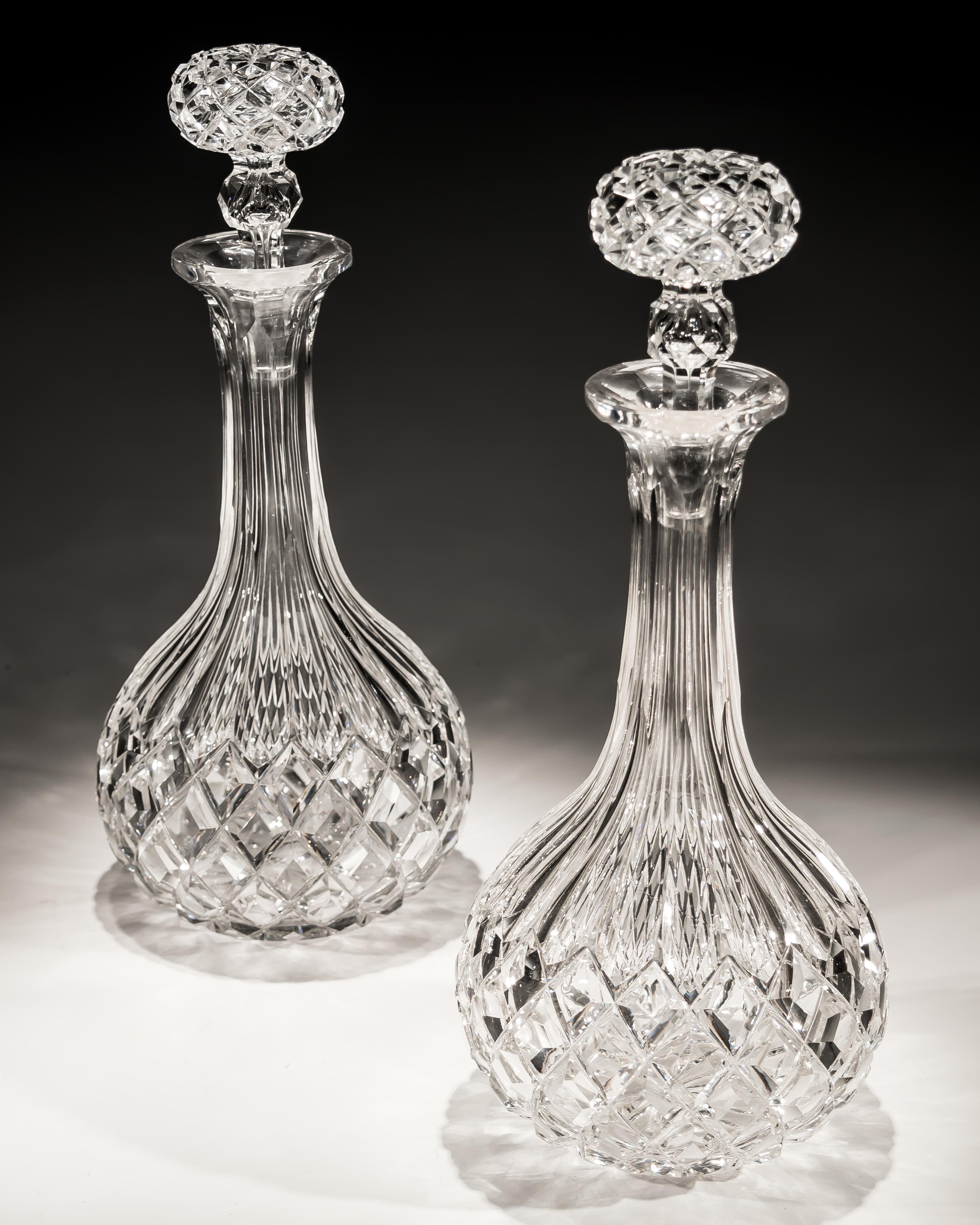 A pair of shaft and globe flat diamond cut Victorian decanters.