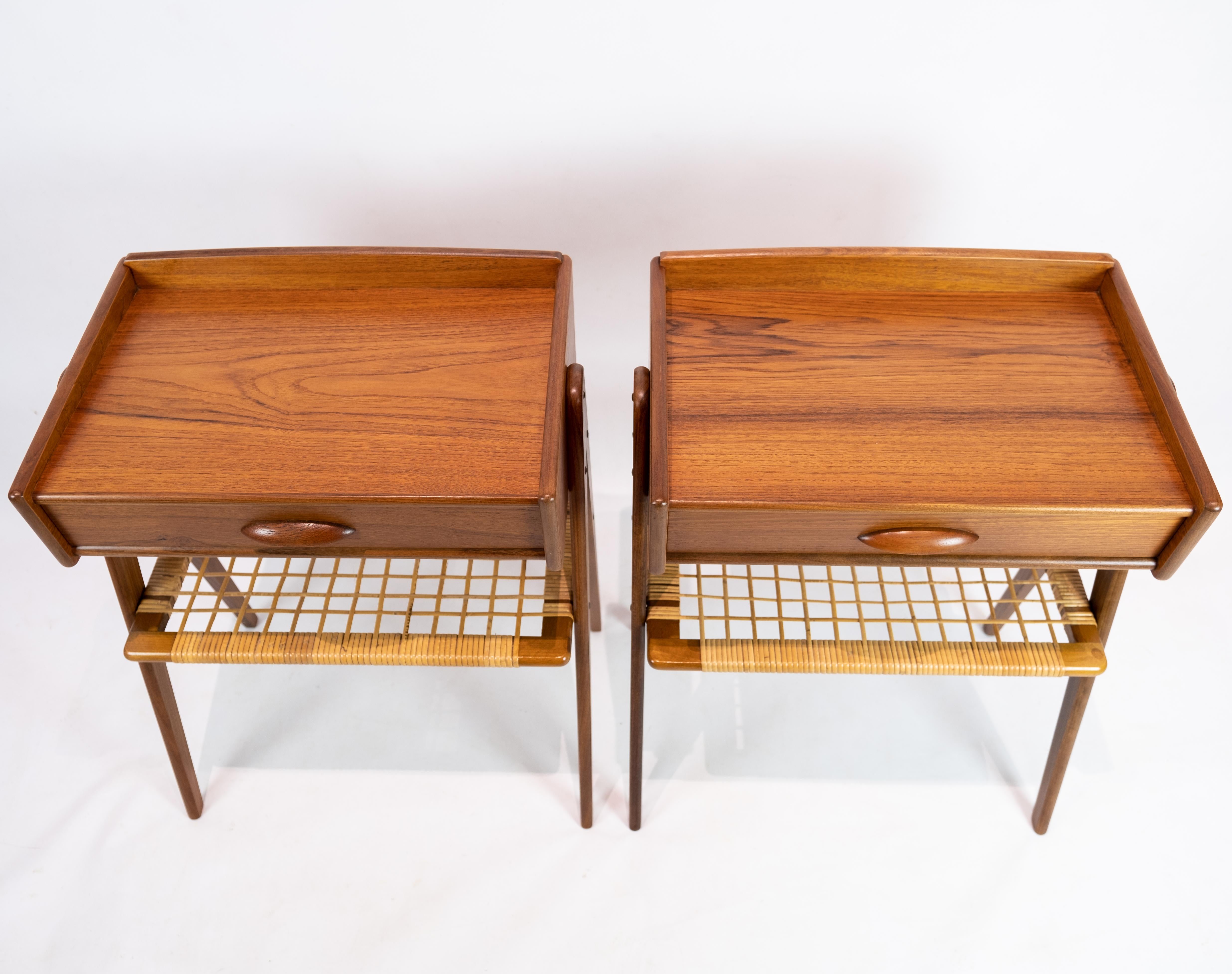A pair of side tables in teak with paper cord shelf of Danish design from the 1960s. The tables are in great vintage condition.