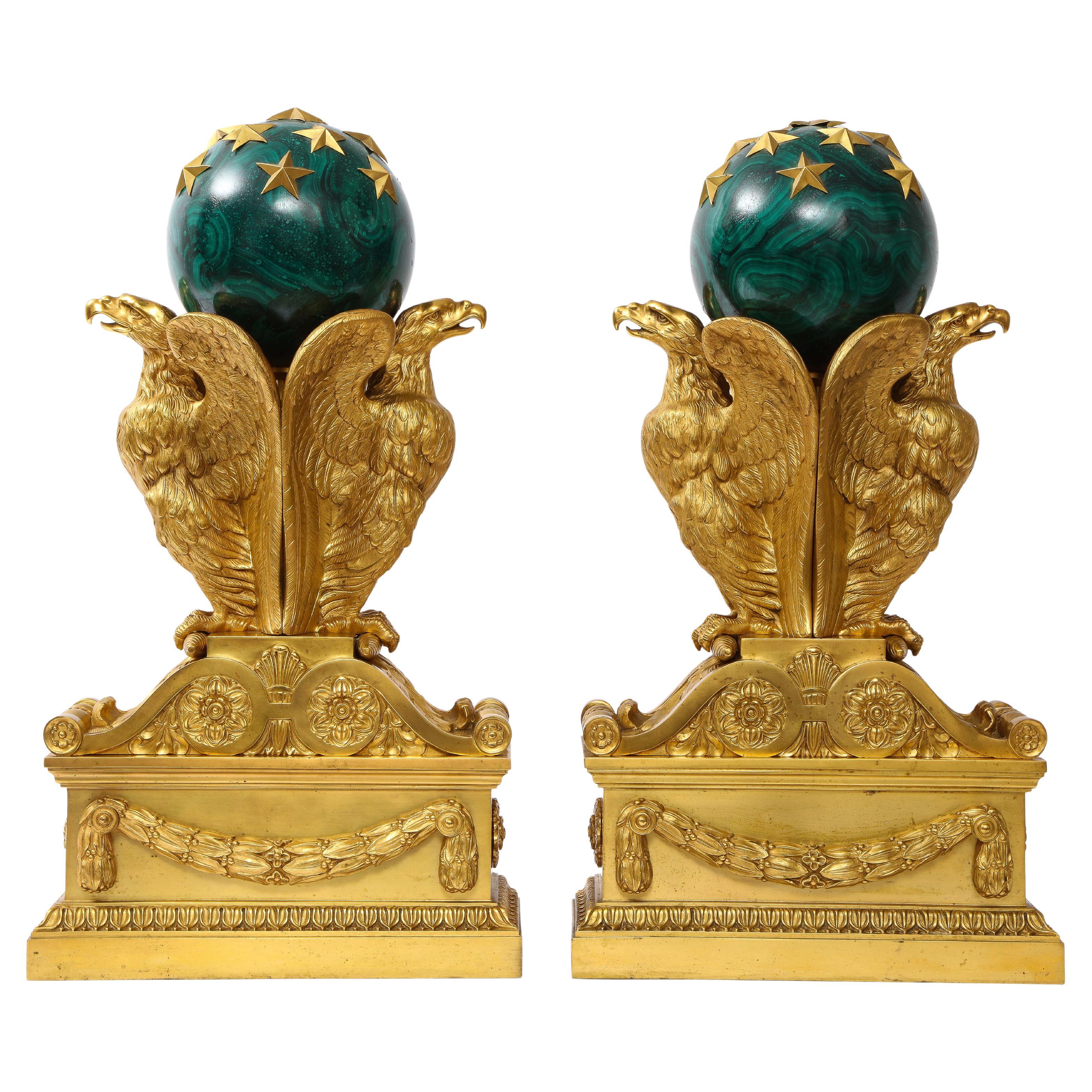 A Pair of Signed French Ormolu Double Eagle Andirons w/ Faux Malachite Globes