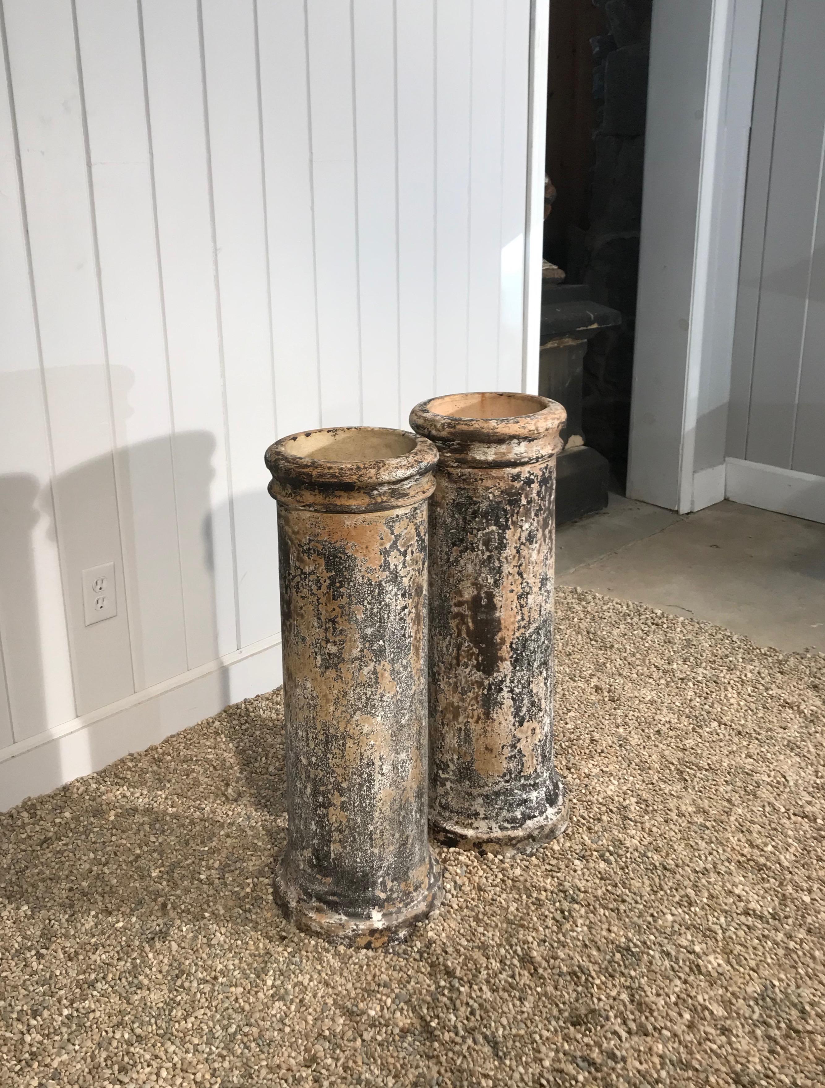 These lovely 19th century English biscuit terracotta chimney pots were hand-patinated for us by an artisan in Spain to a stunning effect. In near-perfect condition without cracks or repairs, they would make wonderful holders for effusive flowering