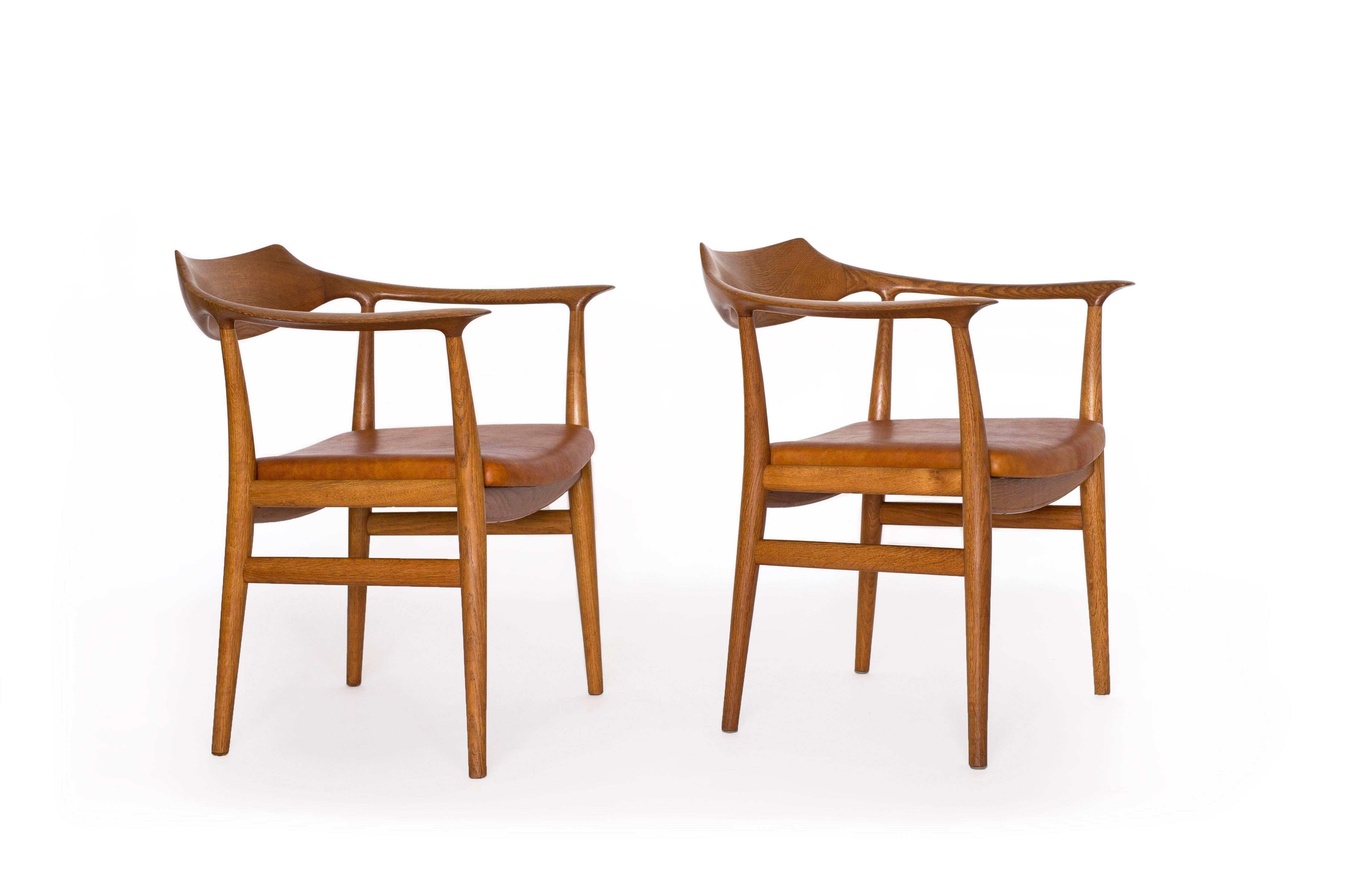 A pair of Sigurd Resell armchairs with frame of oak and seats upholstered with Nigerian leather 

Designed by Sigurd Resell in 1959 and made by cabinetmaker Niels Vodder, Denmark 

Sold and priced as a pair.
 