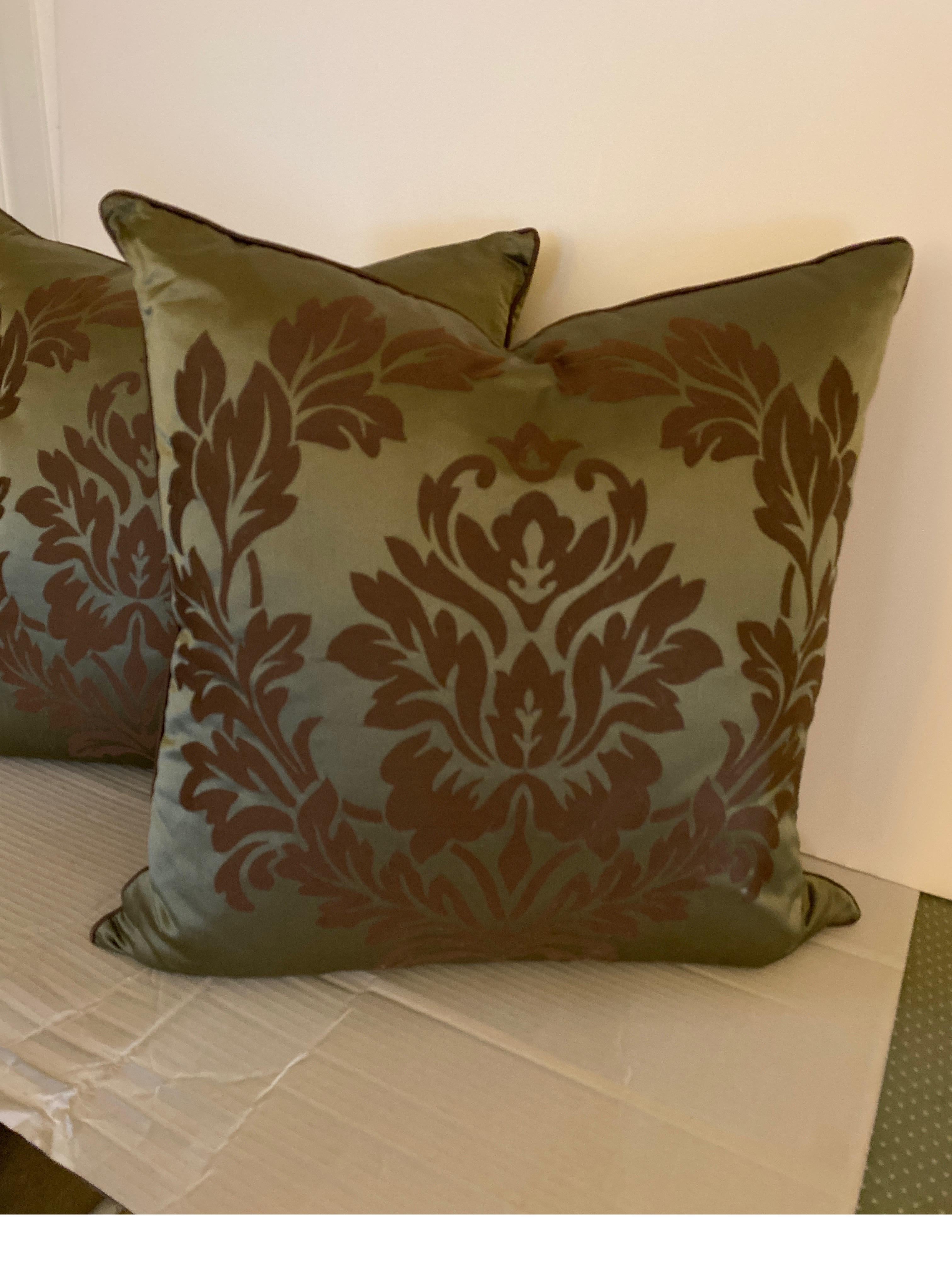 A Pair of pure silk damask pillows with down and feather inserts. The best quality upholstery weight silk fabric with a steel Aqua background with an umber-plum damask pattern. These are patterned on both sides, 18 inches square.