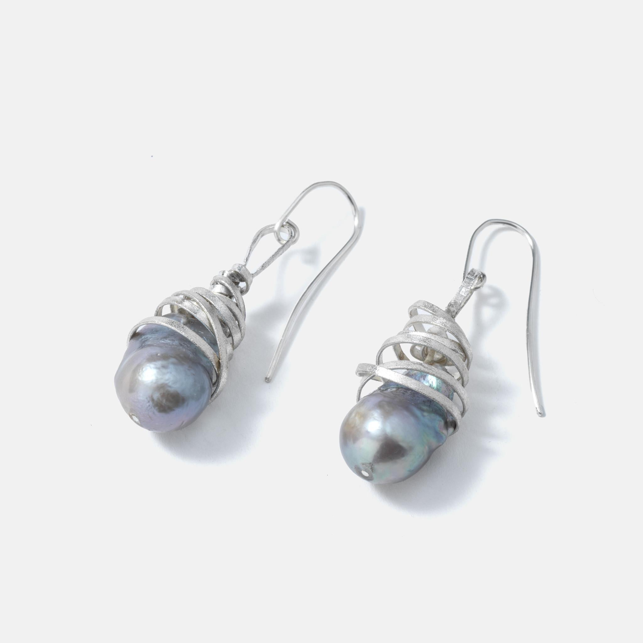A pair of silver and grey pearl ear rings with a unique design. Light to wear and  full of fantasy. They are new and unused. Made by a young silversmith called Åsa Erwall who works in the south of Sweden.