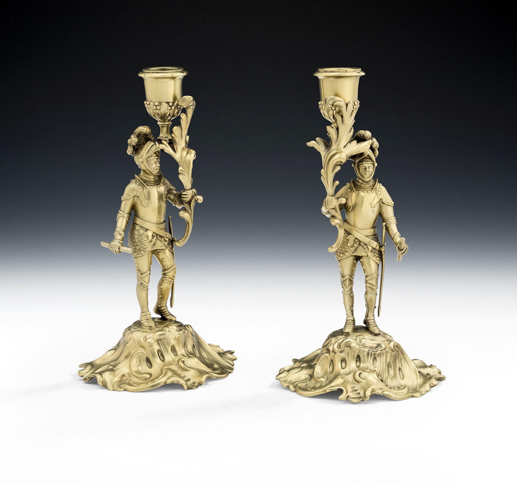 A very rare pair of silver gilt figural cast candlesticks made in London in 1847 by Charles, Thomas & George Fox. These extremely rare, possibly unique, silver gilt candlesticks are cast and stand on domed Rococo bases decorated with swiring