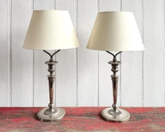 A Pair of Silver Plated Regence Candlestick Table Lamps