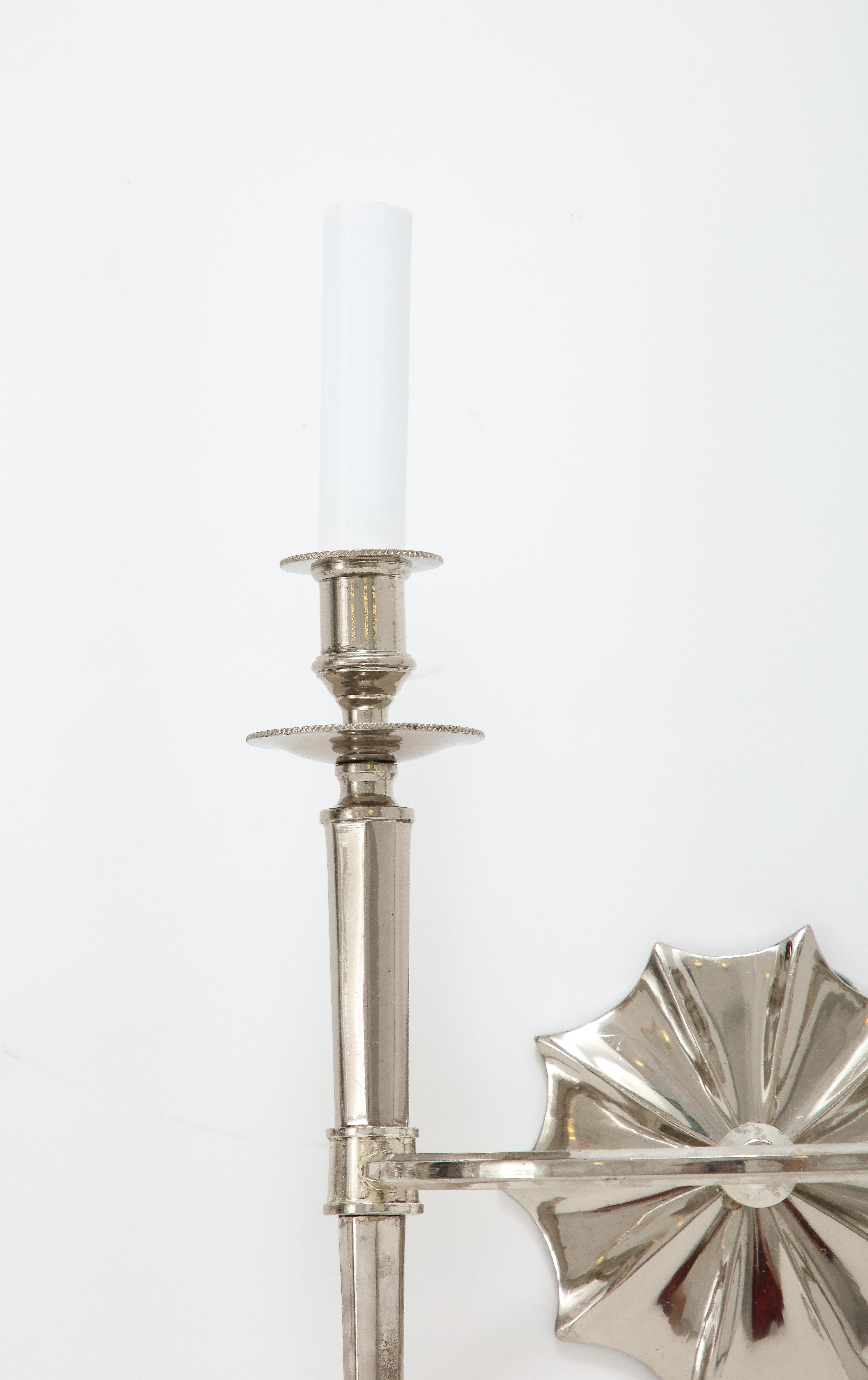 A great looking and unique pair of two-arm wall scones, each with two tapered, faceted candelabra joined by a ring and mounted on a beautiful flower backplate.