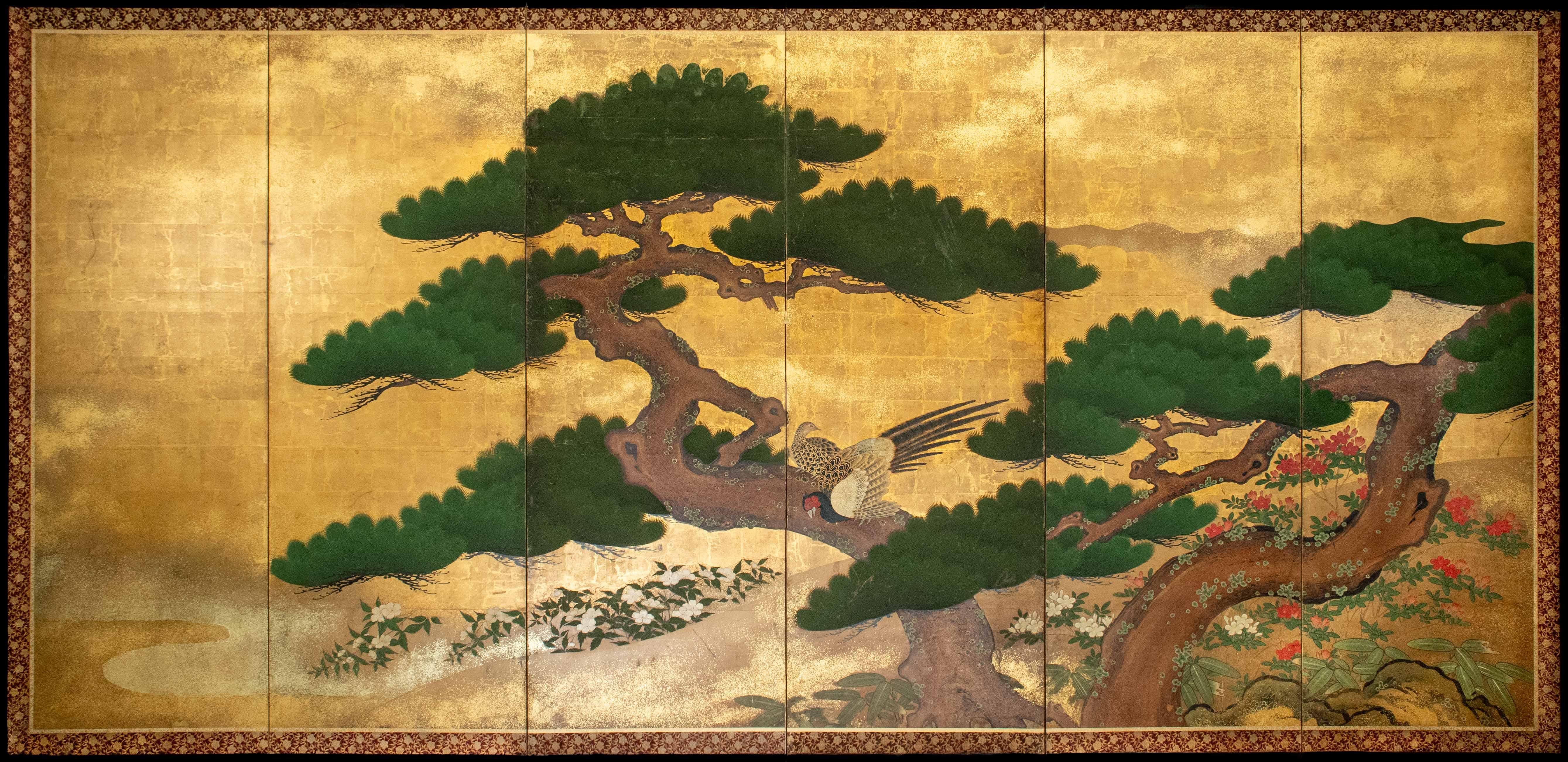 Peint à la main A pair of six-panel folding screens depicting two pine trees (matsu) en vente
