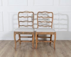 A pair of slender Gustavian chairs with smiling details Circa 1780
