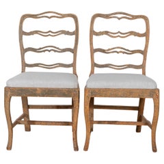 A pair of slender Gustavian chairs with smiling details Circa 1780