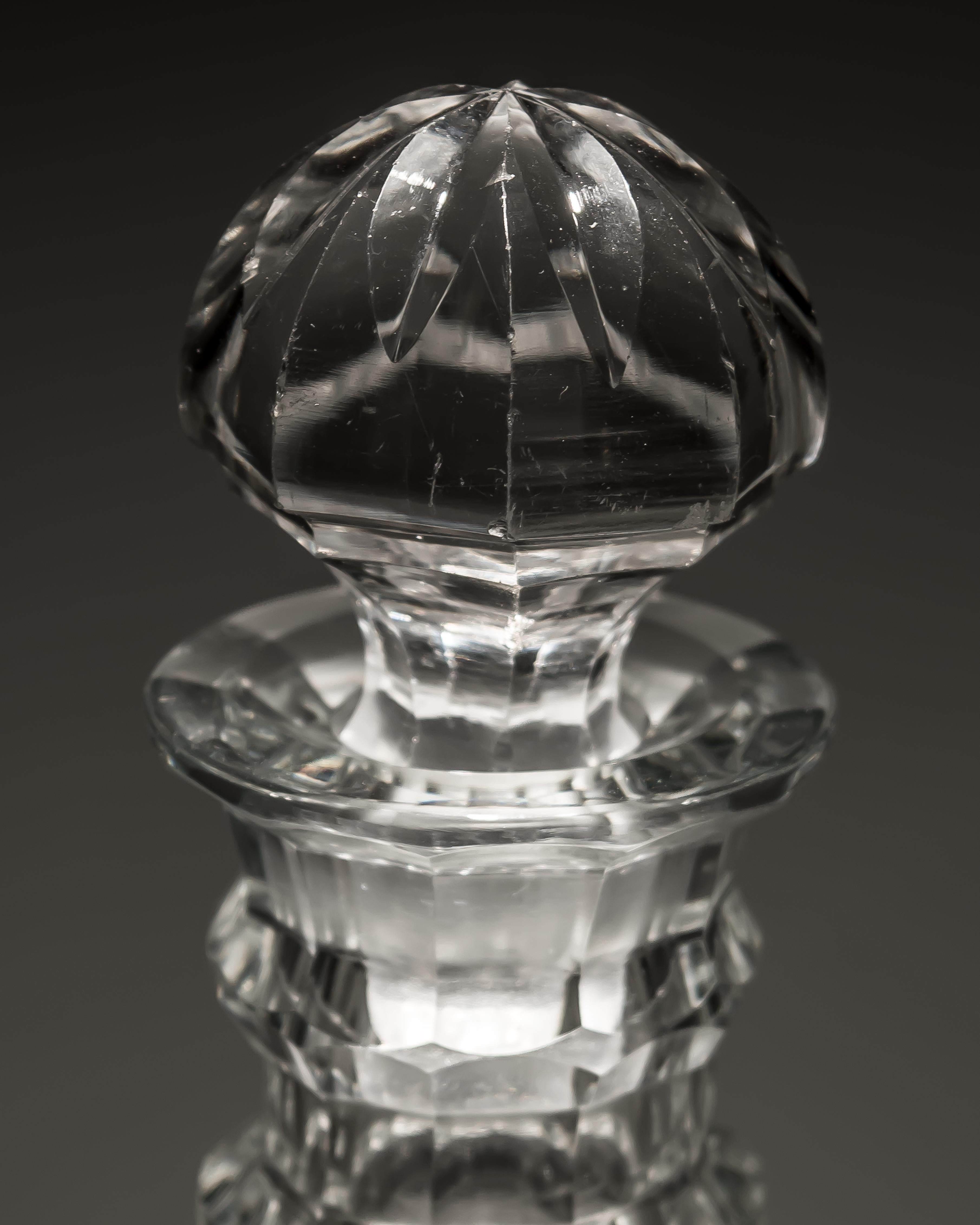 A pair of slice cut Georgian decanters with faceted rings.