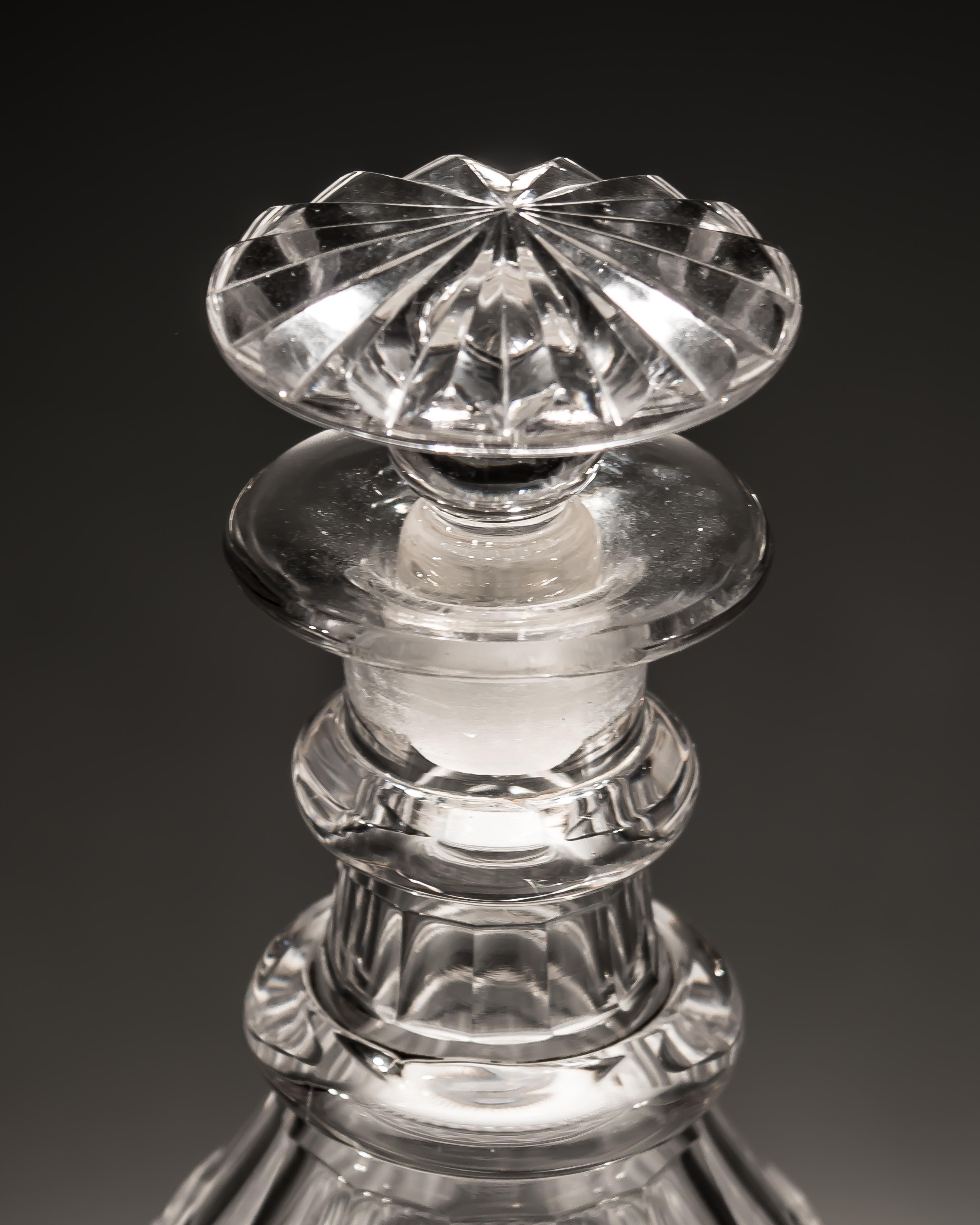 A pair of slice cut Regency decanters with diamond cut band.