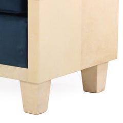 A pair of small parchment covered upholstered benches.