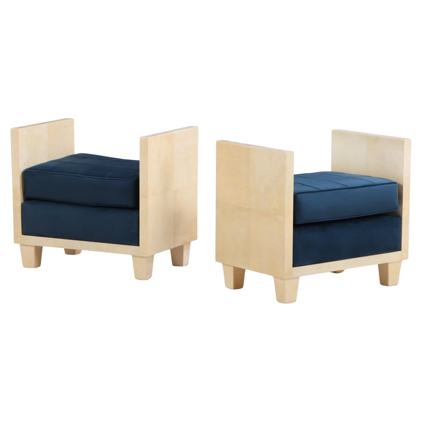 A pair of small parchment covered upholstered benches.