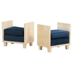 A pair of small parchment covered upholstered benches. A pair of small parchment covered upholstered benches.