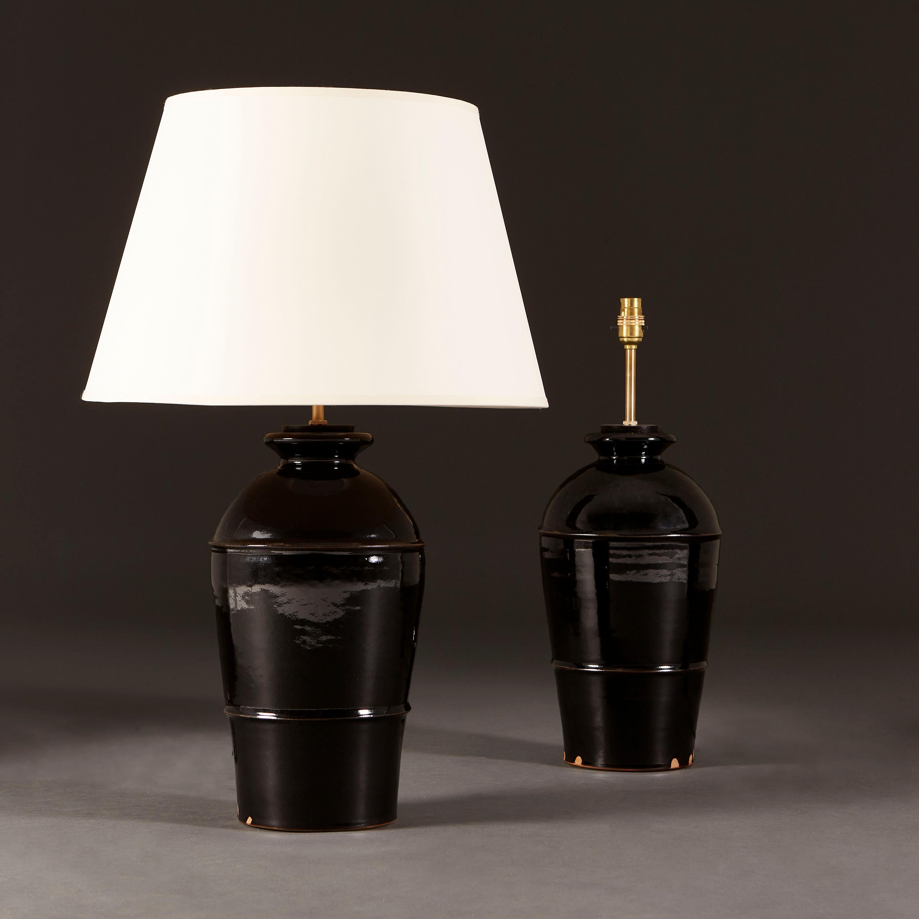 +VAT

England, modern

A pair of Song Dynasty style lamps of large baluster form, with glossy Tenmoku glaze, a term derived from Tenmoku tea-bowls in China. The jars are finished with a pickled oak stopper and polished brass fittings.

Lead time 12