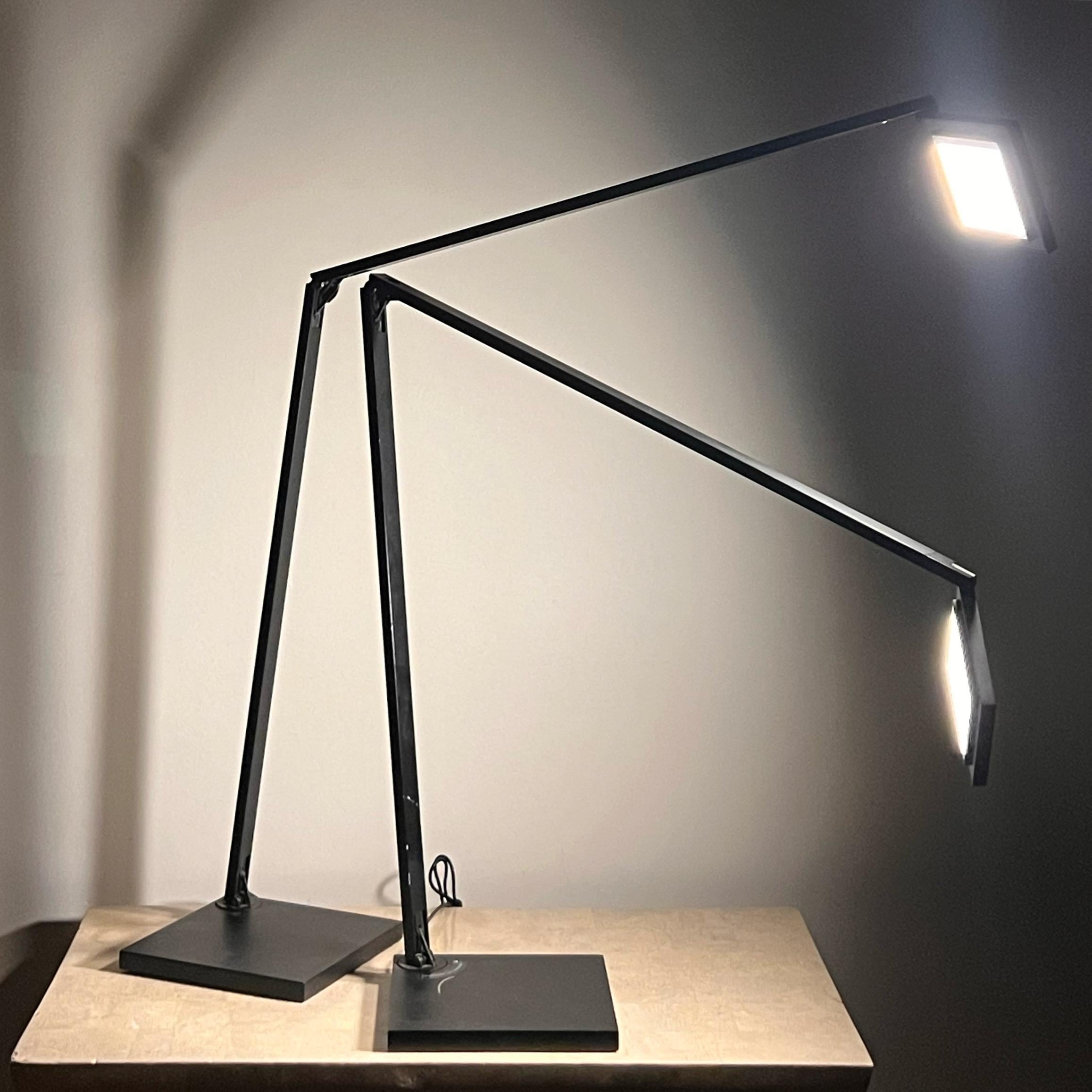 A pair of Quattro modernist task lamps by Sonneman, a Way of Light, early 21st century. Adjustable arm swings 90degrees, and LED lights are tapped to access three lighting settings. Minor signs of age including scuffing on bases, and one of the arms