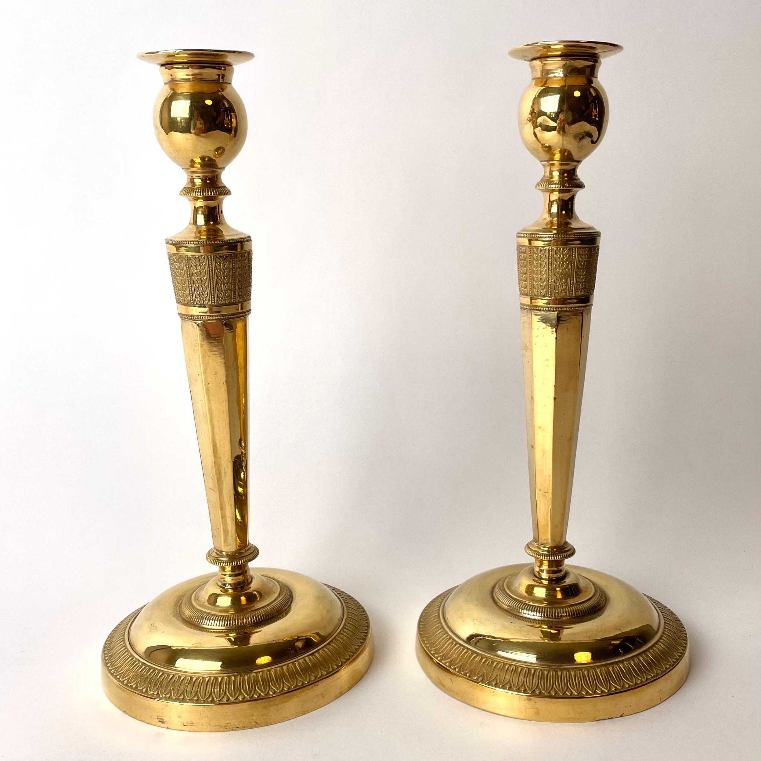 A pair of sophisticated and elegant gilt bronze Candlesticks, Probably made in Paris, France. Directoire circa 1795. Beautifully decorated with leaves.

Wear consistent with age and use.