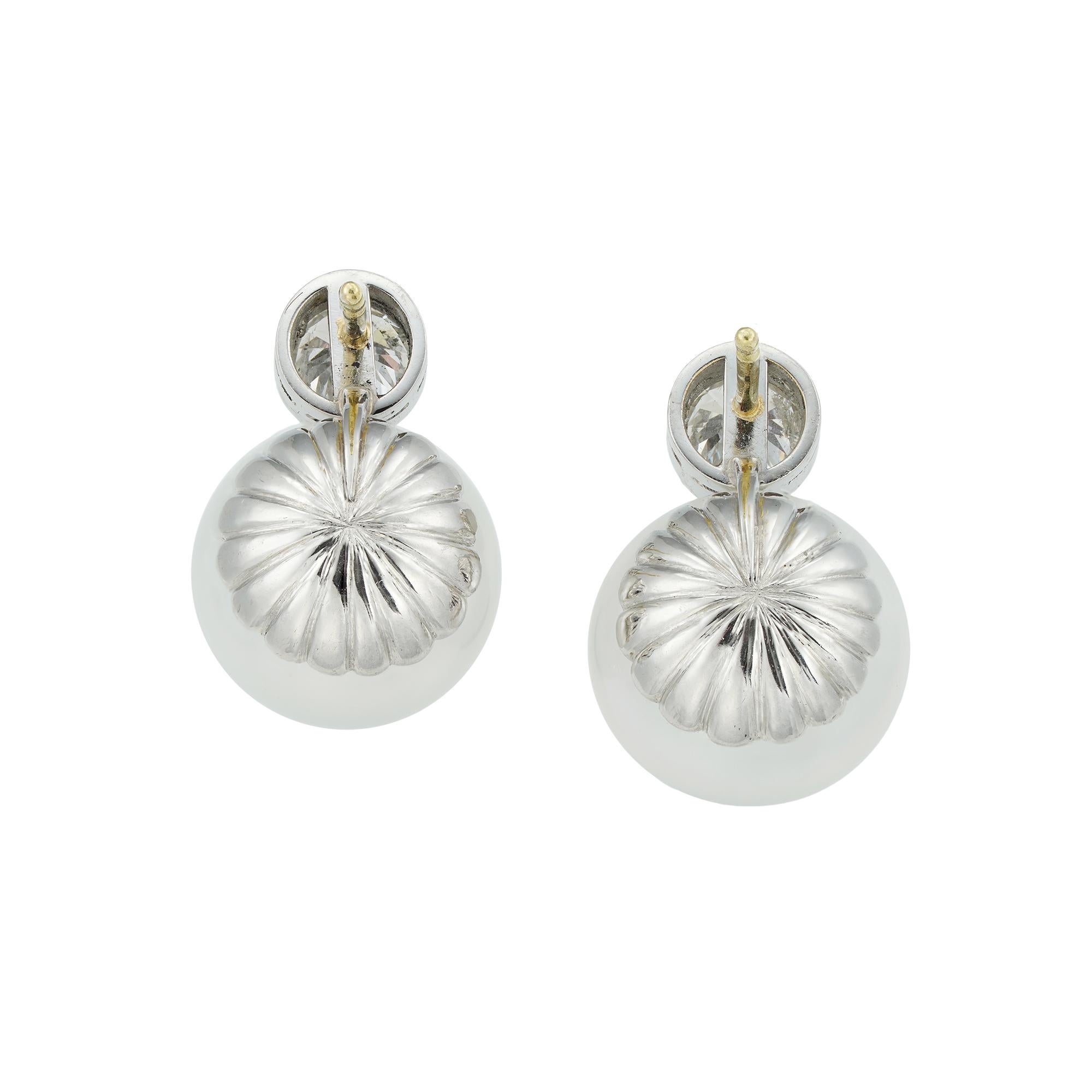 A pair of South Sea cultured pearl and diamond earrings, each earring with a single old brilliant-cut diamond top, the one diamond weighing 0.90 carats and the other 0.91 carats, assessed to be of I-J colour and SI2-I1 clarity, each millegrain-set